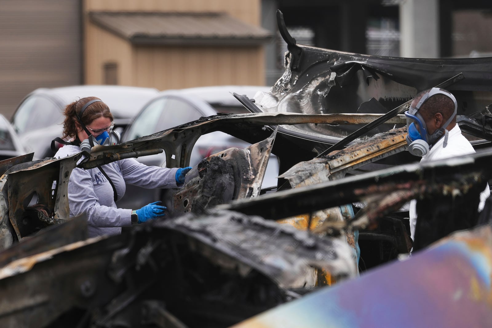 FILE - ATF investigators take apart and document a burned Tesla Cybertruck at a Tesla lot in Seattle, Monday, March 10, 2025. (AP Photo/Lindsey Wasson, File)