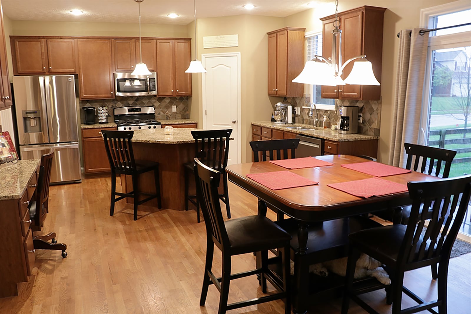 Four separate workstations design the kitchen space with the cooking area near the dining room, preparation station next to the double sink that is under a window, a large island that offers seating and storage, and a planning area or coffee station conveniently located near the breakfast room. CONTRIBUTED PHOTO BY KATHY TYLER