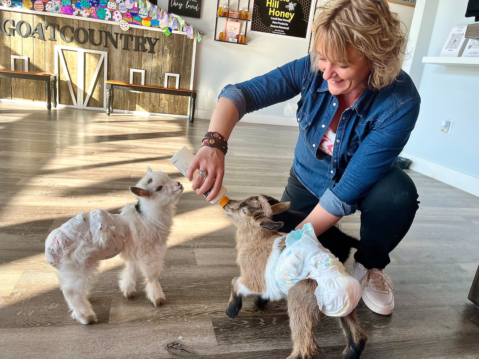 GoatCountry, located at The Greene in Beavercreek near Von Maur, offers goat cuddles, yoga and more. Pictured is Cassie Keeton. NATALIE JONES/STAFF