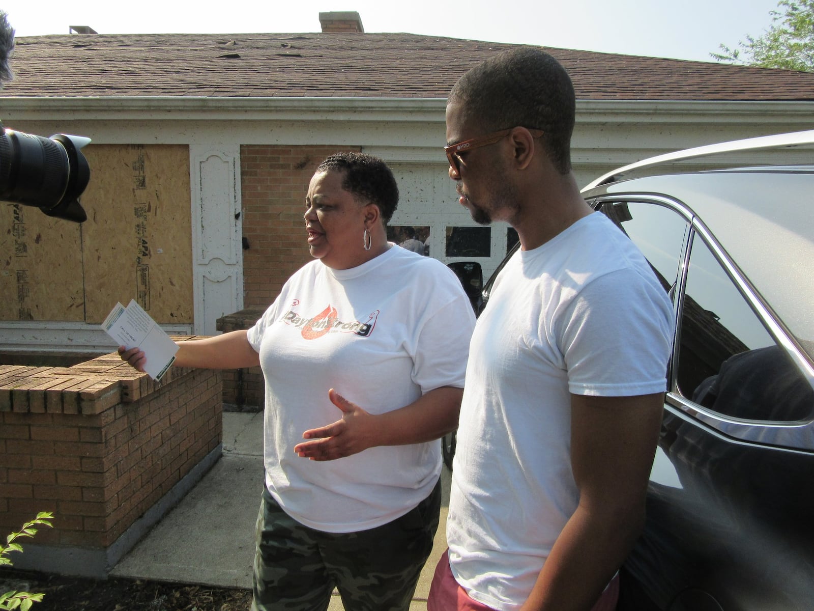 Donna Harrison, 59, of 5274 Bromwick Drive, and her son Tremayne Leonard, 25, of Indianapolis, talk about the tornado and how grateful they are for the help people are giving to clean debris and trees in the tornado-ravaged Trotwood neighborhood on Saturday. PHOTO by Lynn Hulsey