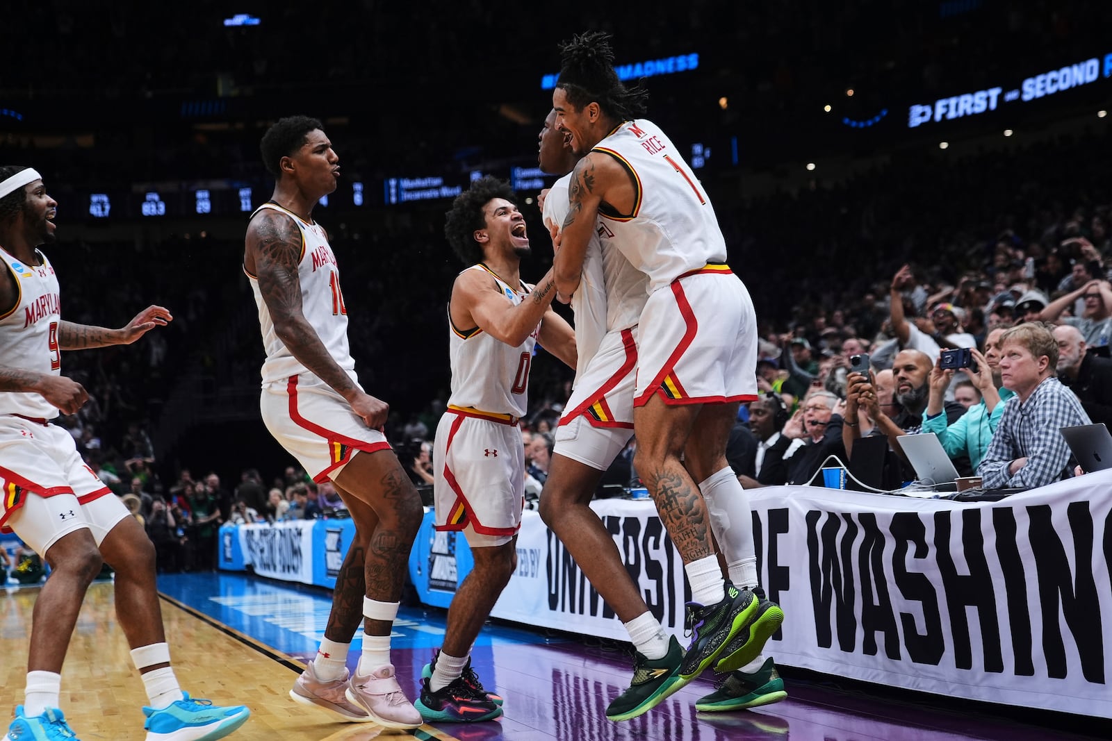 Maryland center Derik Queen, second from right, is mobbed by teammates, including guard Selton Miguel, left, forward Julian Reese, guard Ja'Kobi Gillespie and guard Rodney Rice (1) after making the game-winning basket against Colorado State for a 72-71 win in the second round of the NCAA college basketball tournament Sunday, March 23, 2025, in Seattle. (AP Photo/Lindsey Wasson)