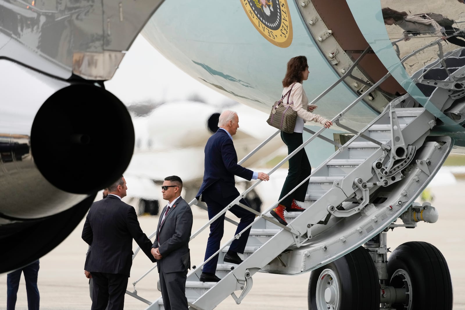 President Joe Biden boards Air Force One, with granddaughter Natalie Biden, to depart Joint Base Andrews, Md., Thursday, Nov. 14, 2024, en route to Lima, Peru to join other world leaders at the APEC Summit. (AP Photo/Ben Curtis)