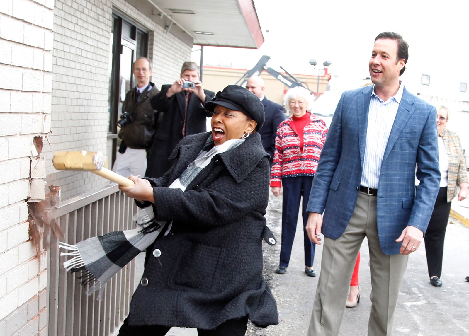 Lu Dale, Huber Heights councilperson, takes a turn at demolishing the McDonald's on Merily Way in 2014 before McDonald's built a new restaurant on the site.  FILE PHOTO / LISA POWELL