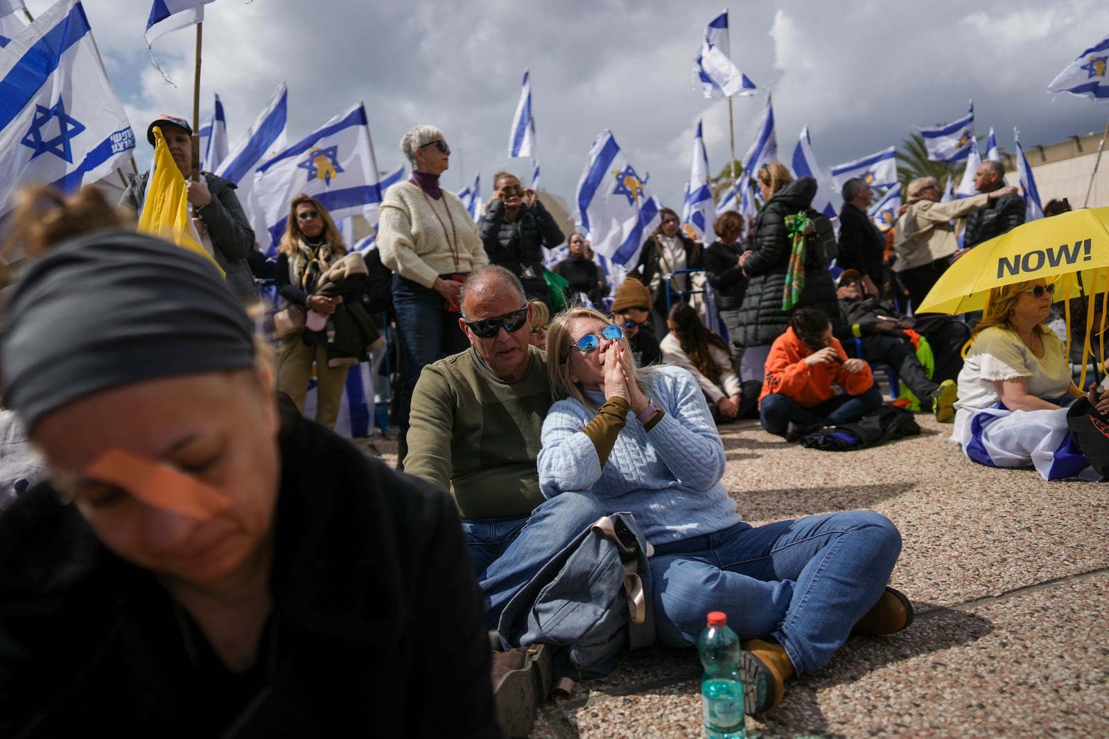 People react at the so-called 'Hostages Square' in Tel Aviv, Israel, Thursday, Feb. 20, 2025, as the bodies of four Israeli hostages, including a mother and her two children, are handed over by Palestinian militant groups to the Red Cross in Gaza. (AP Photo/Oded Balilty)