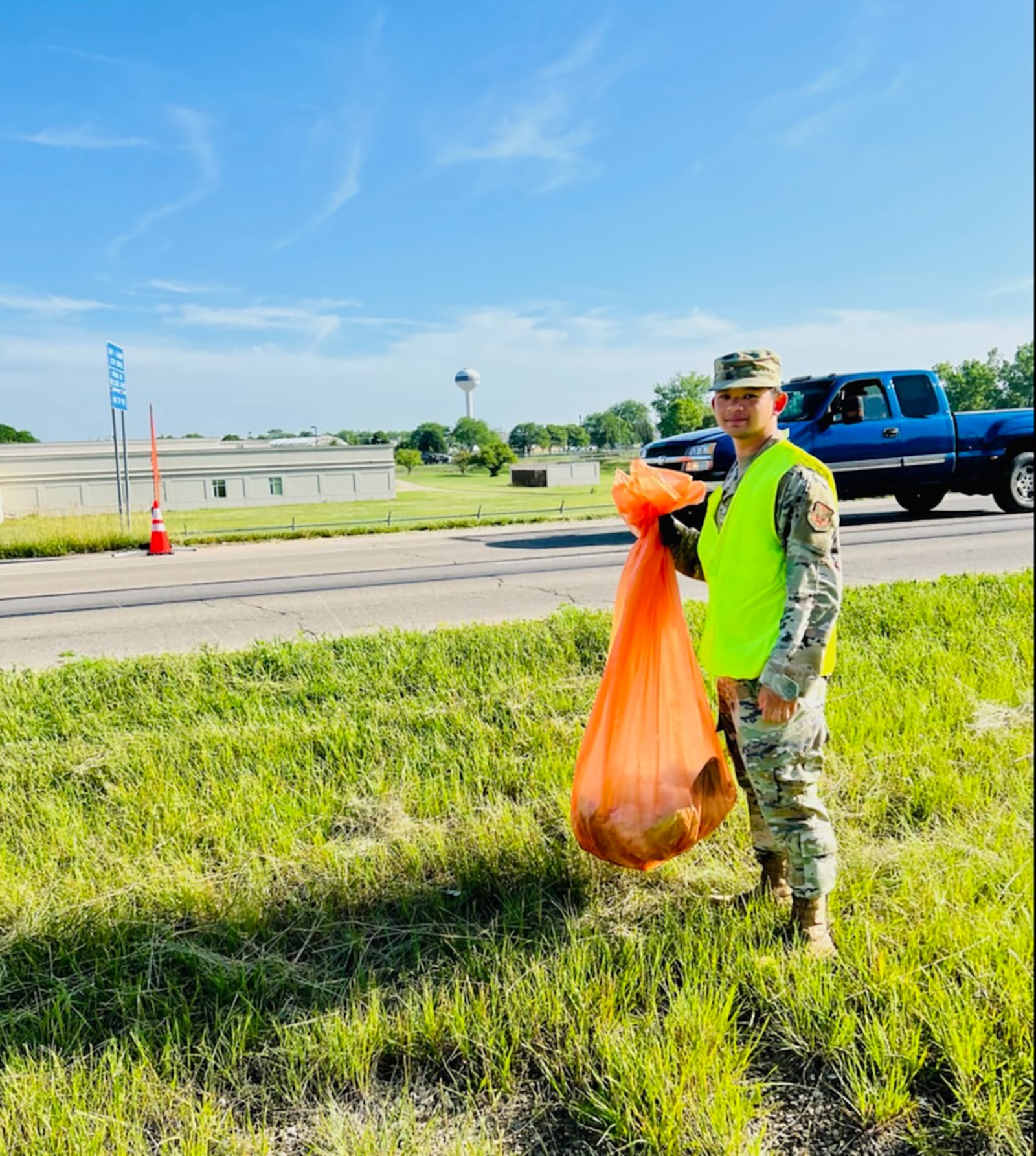 Senior Airman Jasper Kaamino, National Air and Space Intelligence Center analyst, volunteers to pick up litter June 16 on the roads outside Wright-Patterson Air Force Base. CONTRIBUTED PHOTO