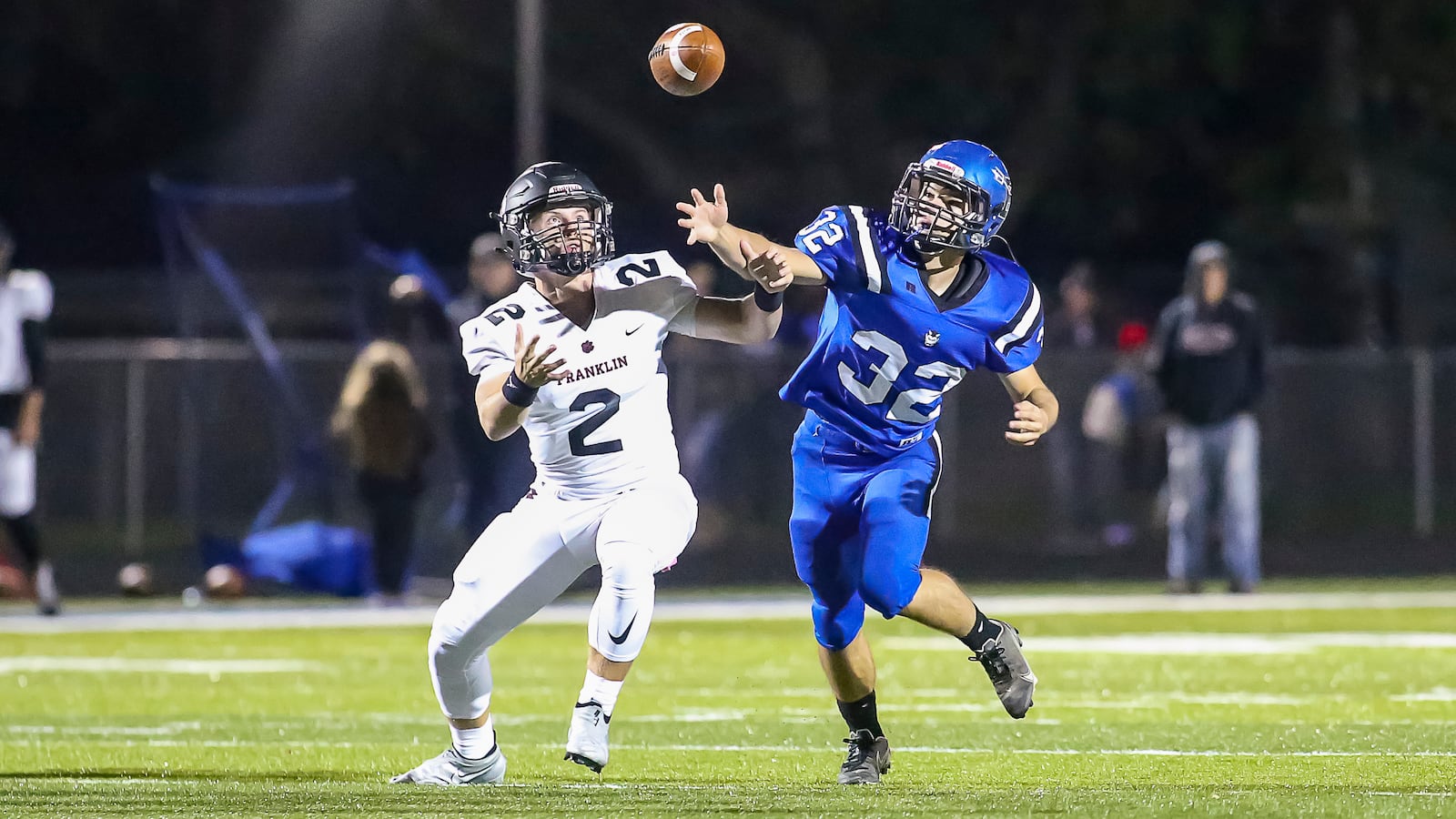 Franklin High School senior Tressel Gibson and Brookville junior Grady Lamb watch as the ball flies out of Gibson's hands during their game on Thursday night in Brookville. Gibson caught the ball and continued to run the play up the field on the play. Brookville won 21-7. CONTRIBUTED PHOTO BY MICHAEL COOPER