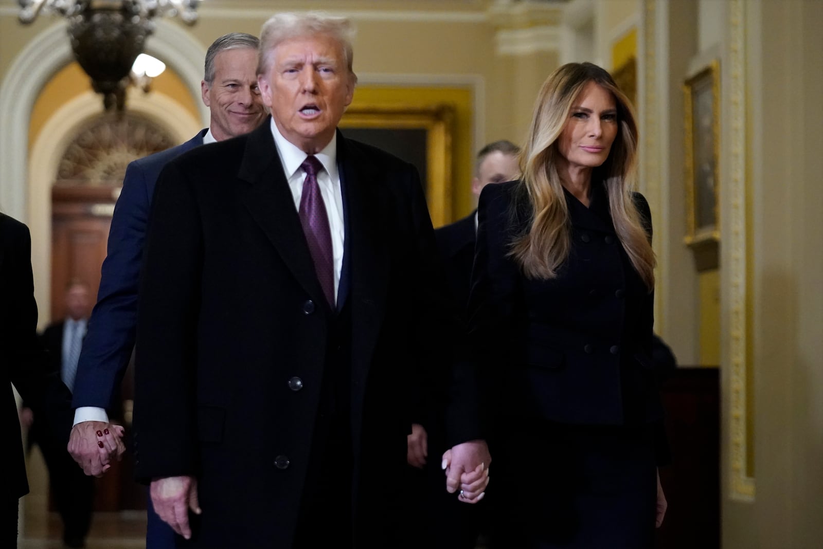 President-elect Donald Trump walks with Melania Trump at the Capitol Wednesday, Jan. 8, 2025, in Washington, as Senate Majority Leader John Thune, R-S.D., follows. (AP Photo/Jose Luis Magana)