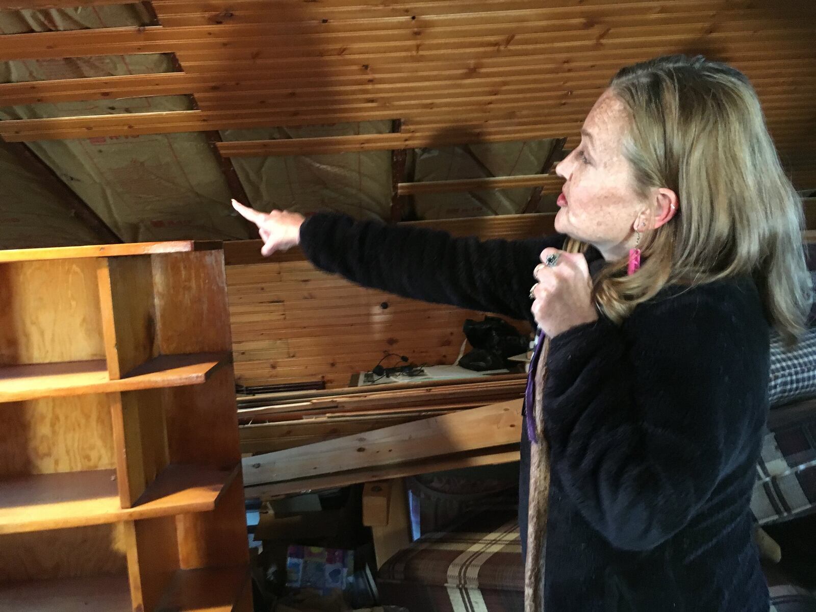 Julia Stewart points out evidence that the roof on her Beavercreek home is sagging since the Memorial Day tornadoes. An engineer she hired said the damage was caused by the tornado, but her insurance company is refusing the claim.