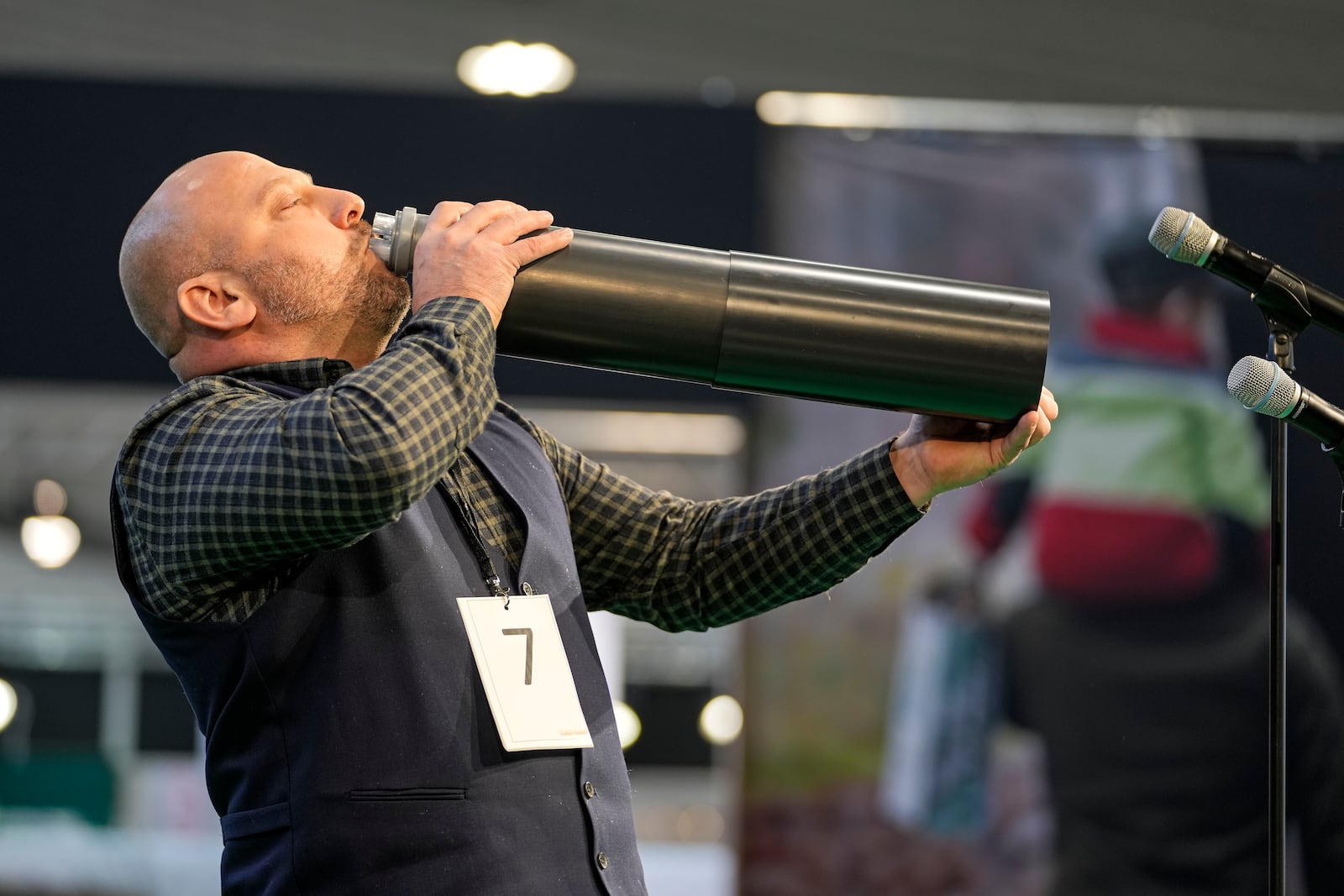 Stefan Lamoly performs to imitate a stag in heat during the German Championship of Deer-Calling at the hunting fair in Dortmund, Germany, Friday, Jan. 31, 2025. (AP Photo/Martin Meissner)