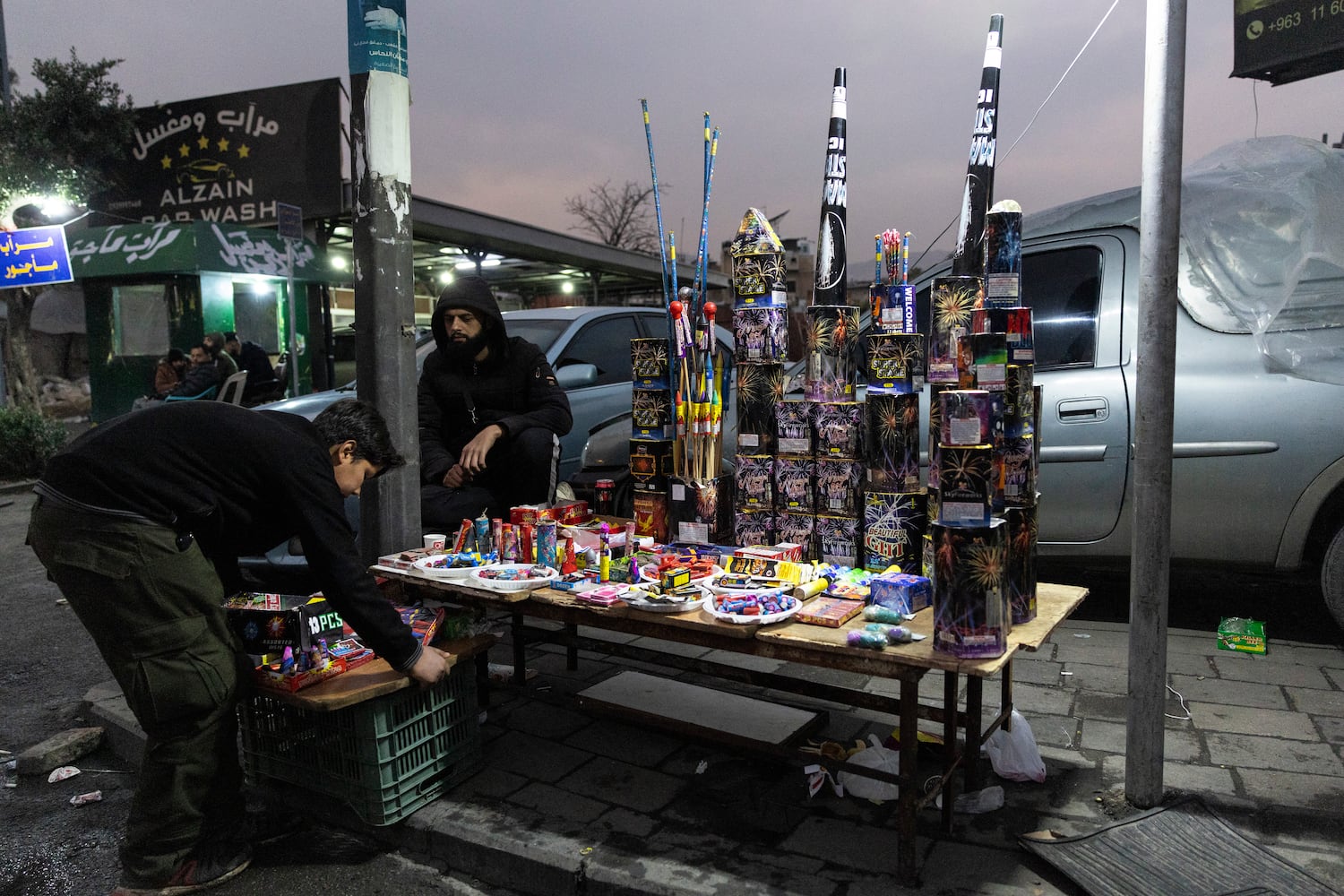 Vendors sell fireworks on the sidewalk on New Year’s Eve in Damascus, Syria, on Tuesday, Dec. 31, 2024. (David Guttenfelder/The New York Times)