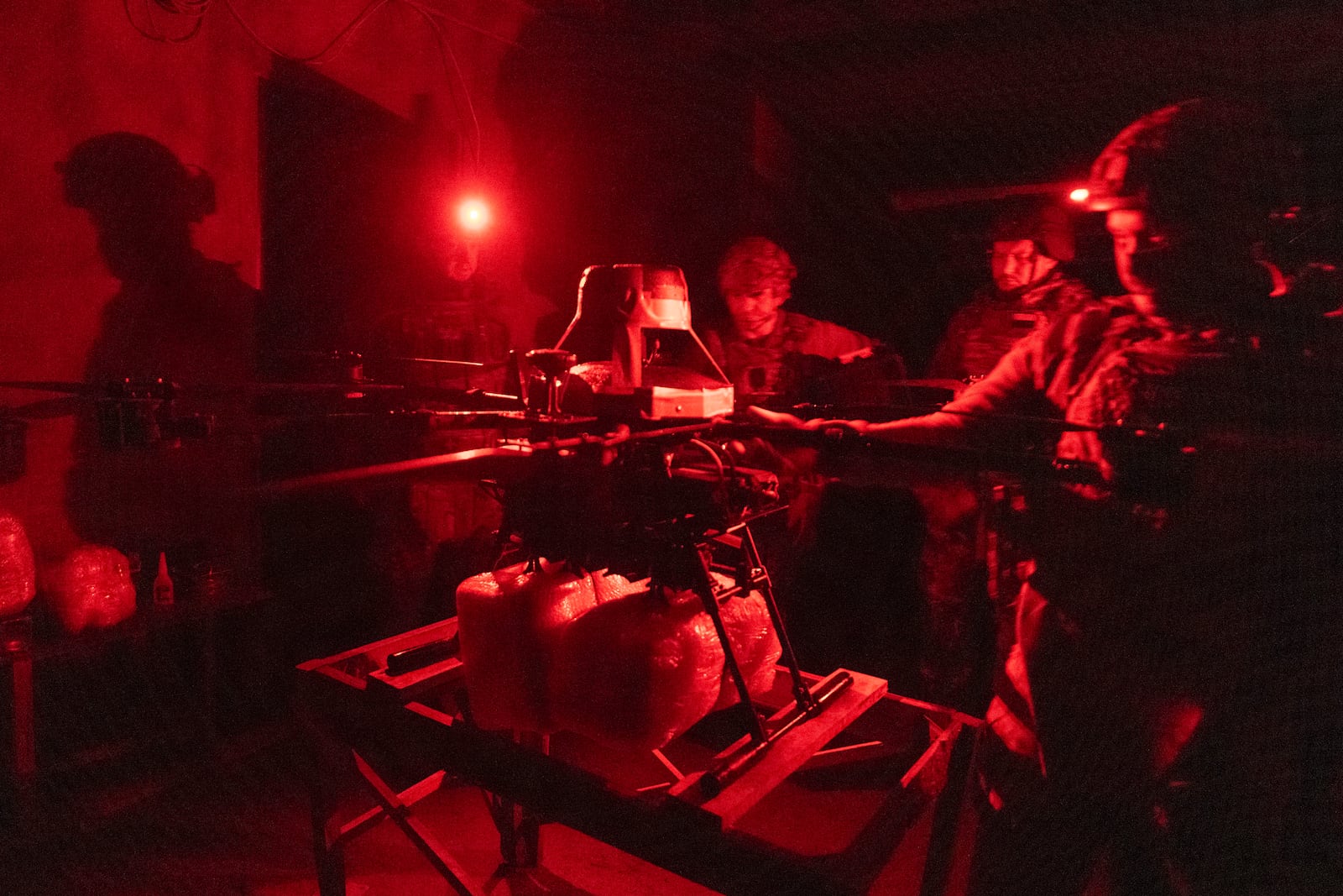 Servicemen of Ukraine's Khartia brigade pack a Vampire drone with food and water to launch toward the frontline to Ukrainian positions near Kharkiv, Ukraine, late Thursday, Nov. 7, 2024. (AP Photo/Efrem Lukatsky)