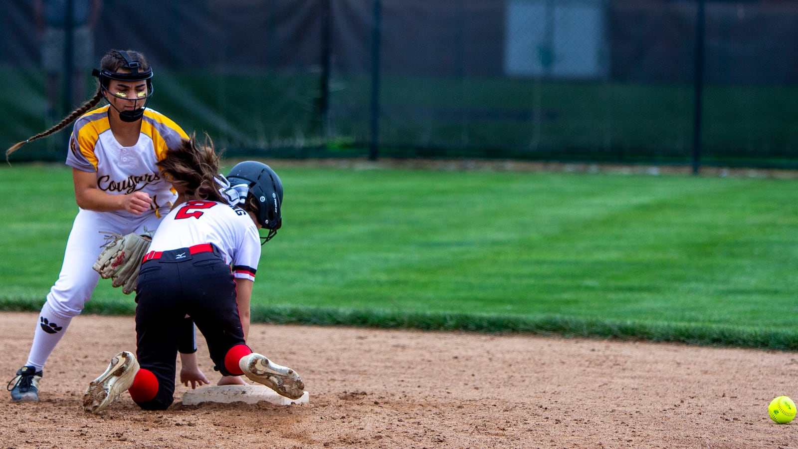 The ball gets past Kenton Ridge second baseman Jacee Hamilton on a throwing error during the sixth inning Saturday in the Division II region final at Mason. The baserunner was tagged out by Hamilton in a rundown between second and third base, but an obstruction ruling allowed the runner to return to second base. Photo by Jeff Gilbert