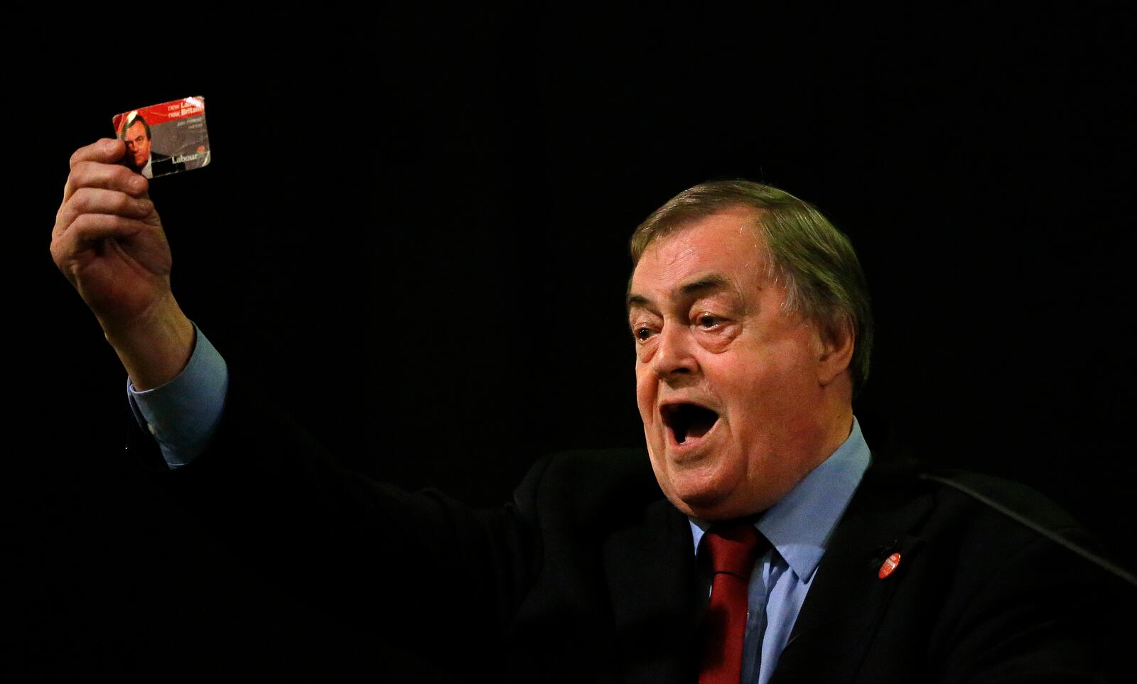 FILE -Former Deputy leader of the Britain's Labour Party, John Prescott, holds up his Labour Party membership card as he gives a speech at a campaign rally for Andy Burnham, the Labour party leadership hopeful, at the St Pancras Parish Church in London, Aug. 24, 2015. (AP Photo/Frank Augstein, File)