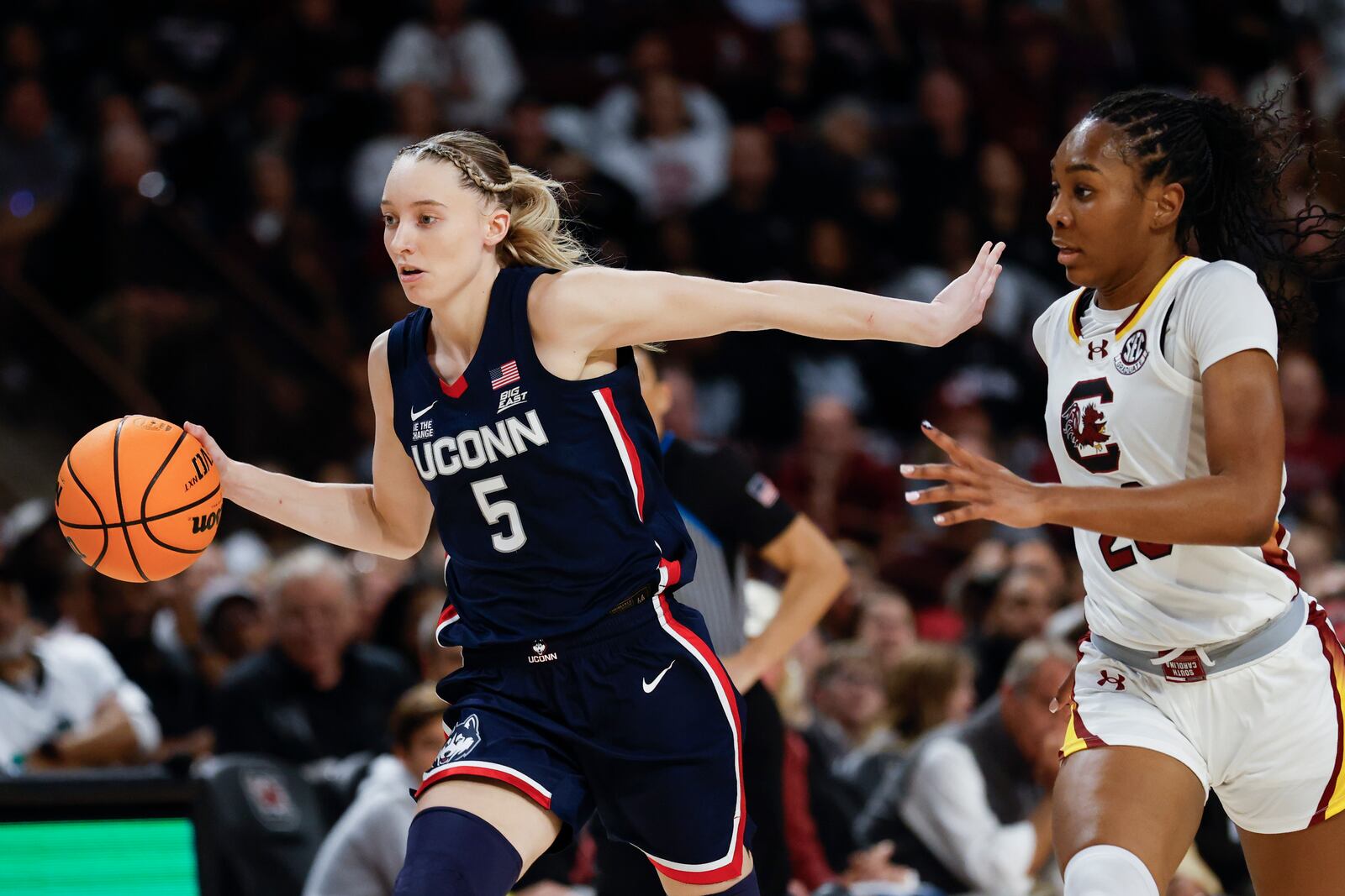 UConn guard Paige Bueckers (5) pushes the ball upcourt past South Carolina guard Bree Hall during the second half of an NCAA college basketball game in Columbia, S.C., Sunday, Feb. 16, 2025. (AP Photo/Nell Redmond)