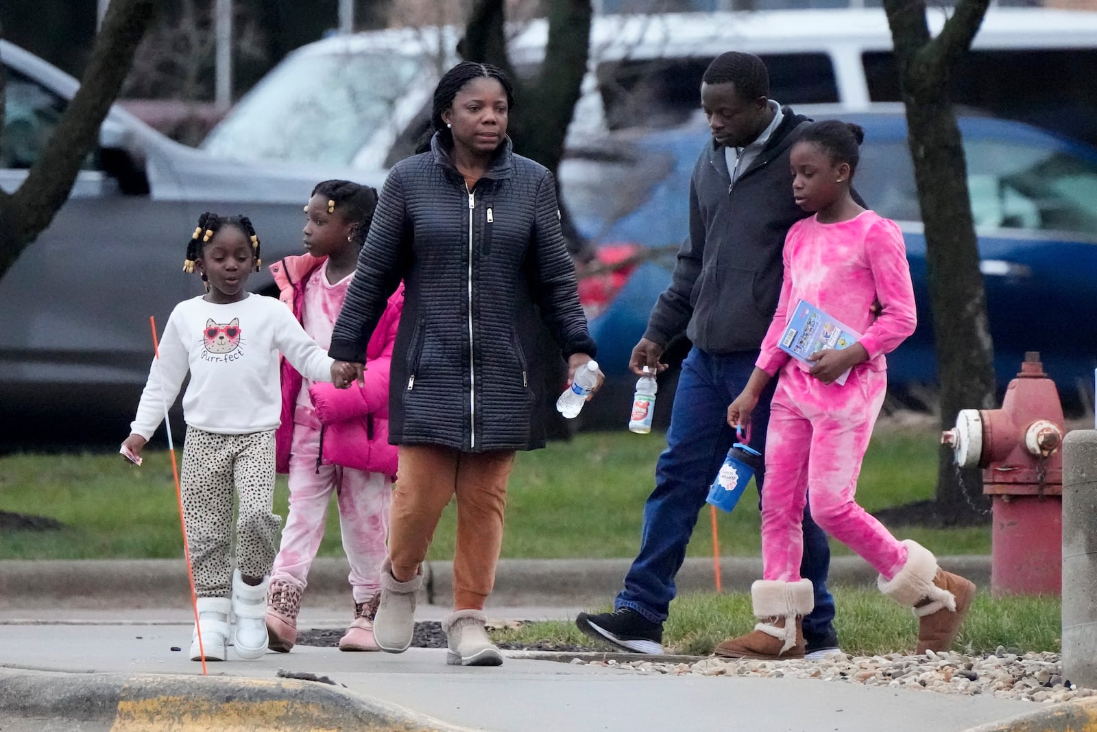 Family leaves from a shelter at the Abundant Life Christian School in Madison, Wis., following a shooting, Monday, Dec. 16, 2024. (AP Photo/Morry Gash)