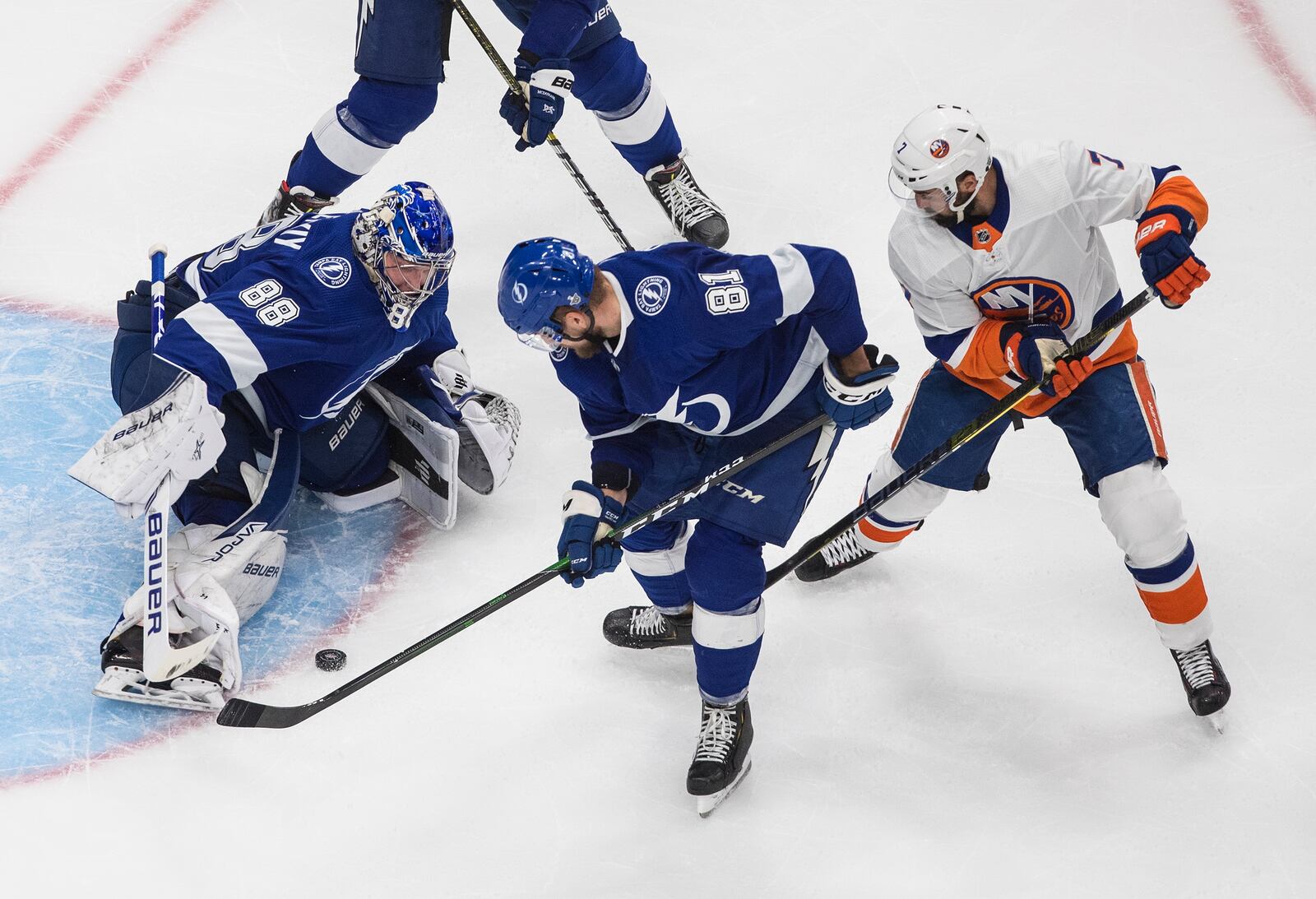 Tampa Bay Lightning goalie Andrei Vasilevskiy (88) makes the save on New York Islanders' Jordan Eberle (7), while Lightning's Erik Cernak (81) picks up the rebound during the second period of Game 2 of the NHL hockey Eastern Conference final, Wednesday, Sept. 9, 2020, in Edmonton, Alberta. (Jason Franson/The Canadian Press via AP)