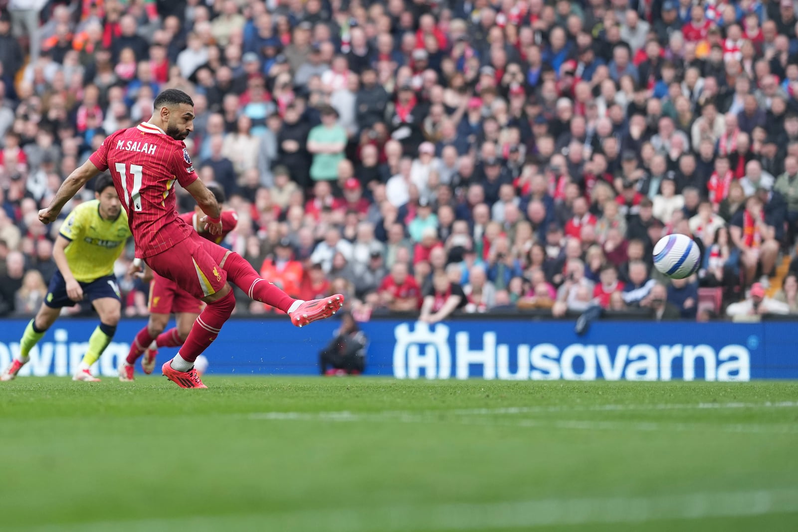 Liverpool's Mohamed Salah scores on a penalty kick during the English Premier League soccer match between Liverpool and Southampton at Anfield in Liverpool, Saturday, March 8, 2025. (AP Photo/Jon Super)