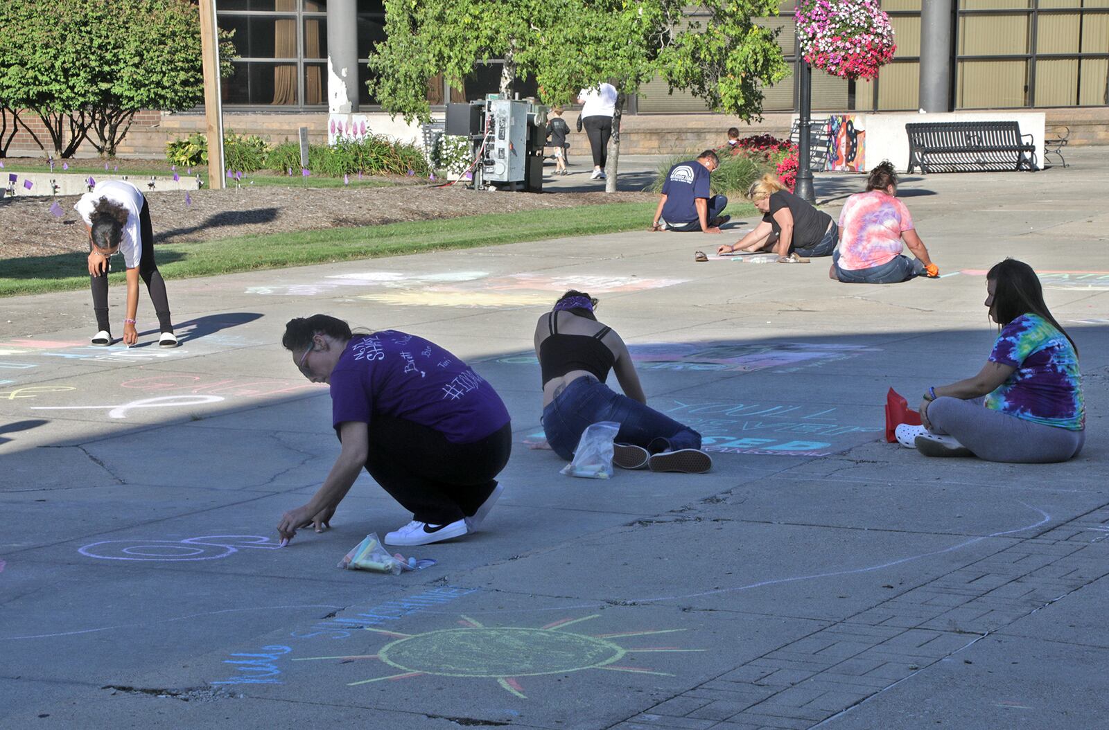 People write motivational message and inspiring pictures on the Springfield City Hall Plaza Wednesday, August 31, 2022 during the first ever Chalk the Walk to celebrate the memory of those lost to substance overdose and help prevent future overdoses. Chalk the Walk coincided with International Overdose Awareness Day. The event, presented by the Clark County Substance Abuse Coalition in collaboration with Clark County Partners in Prevention, also featured overdose prevention resources including free Narcan kits. BILL LACKEY/STAFF