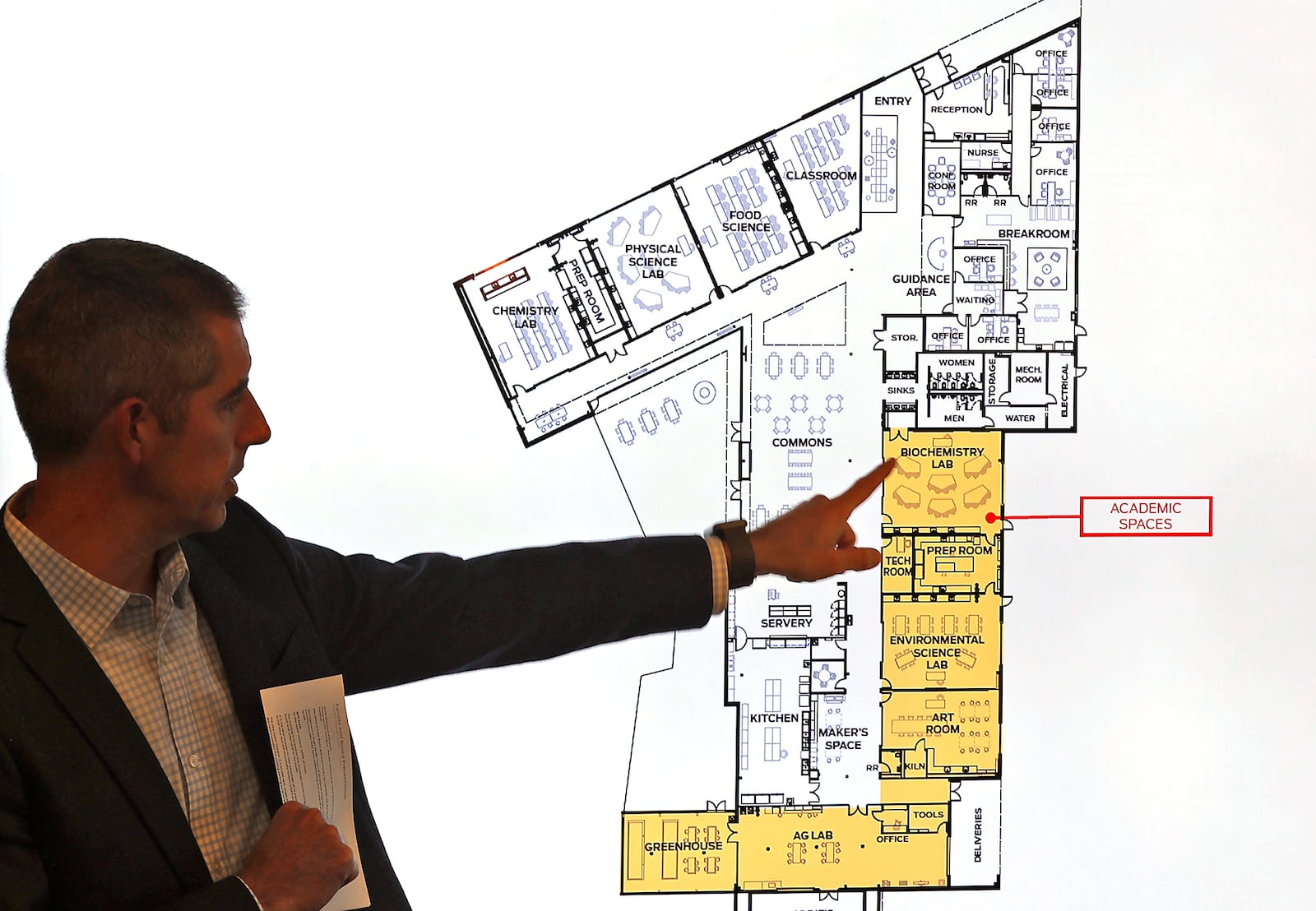 Architect Todd Boyer, from WSA Studio, talks about the new Global Impact STEM Academy building that his company designed on the Clark State College campus during a GISA board meeting Tuesday, Nov. 14, 2023. BILL LACKEY/STAFF