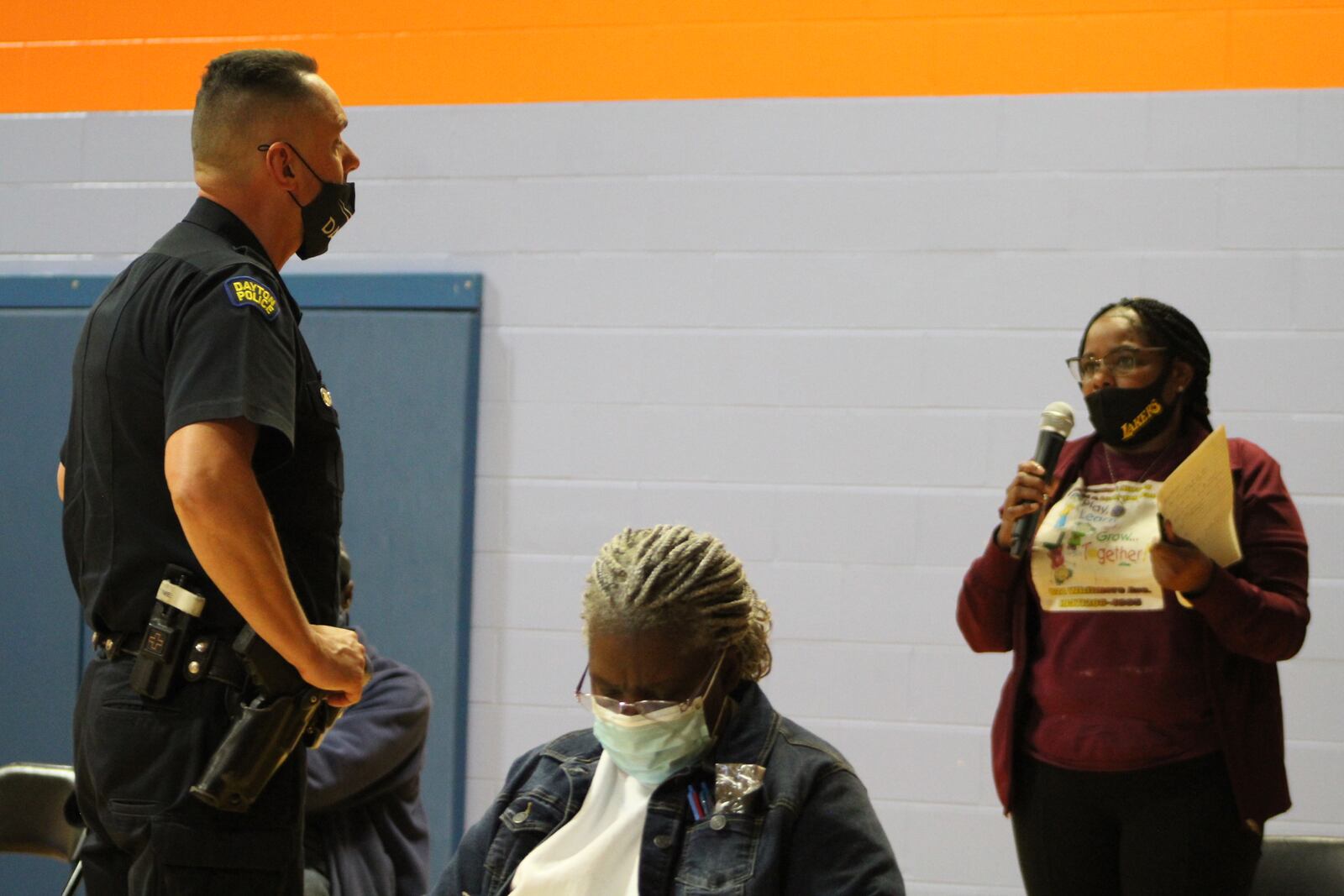 Dan Mamula, the community engagement officer with the Dayton police's West Patrol Operations Division, listens as Terri Sims talks about some of her neighborhood's public safety concerns. CORNELIUS FROLIK / STAFF