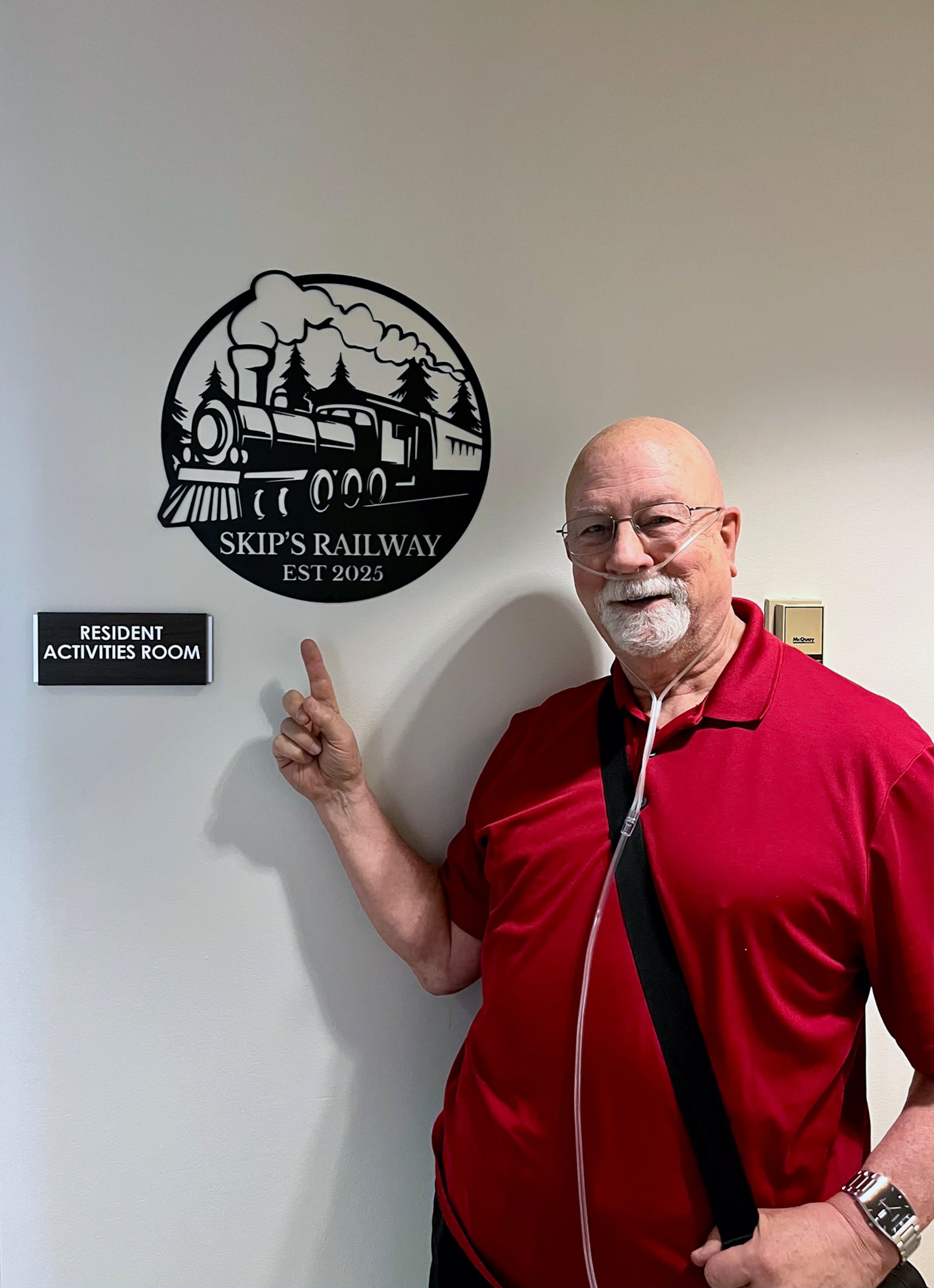 Erhardt in front of the train room at Bethany Lutheran Village.