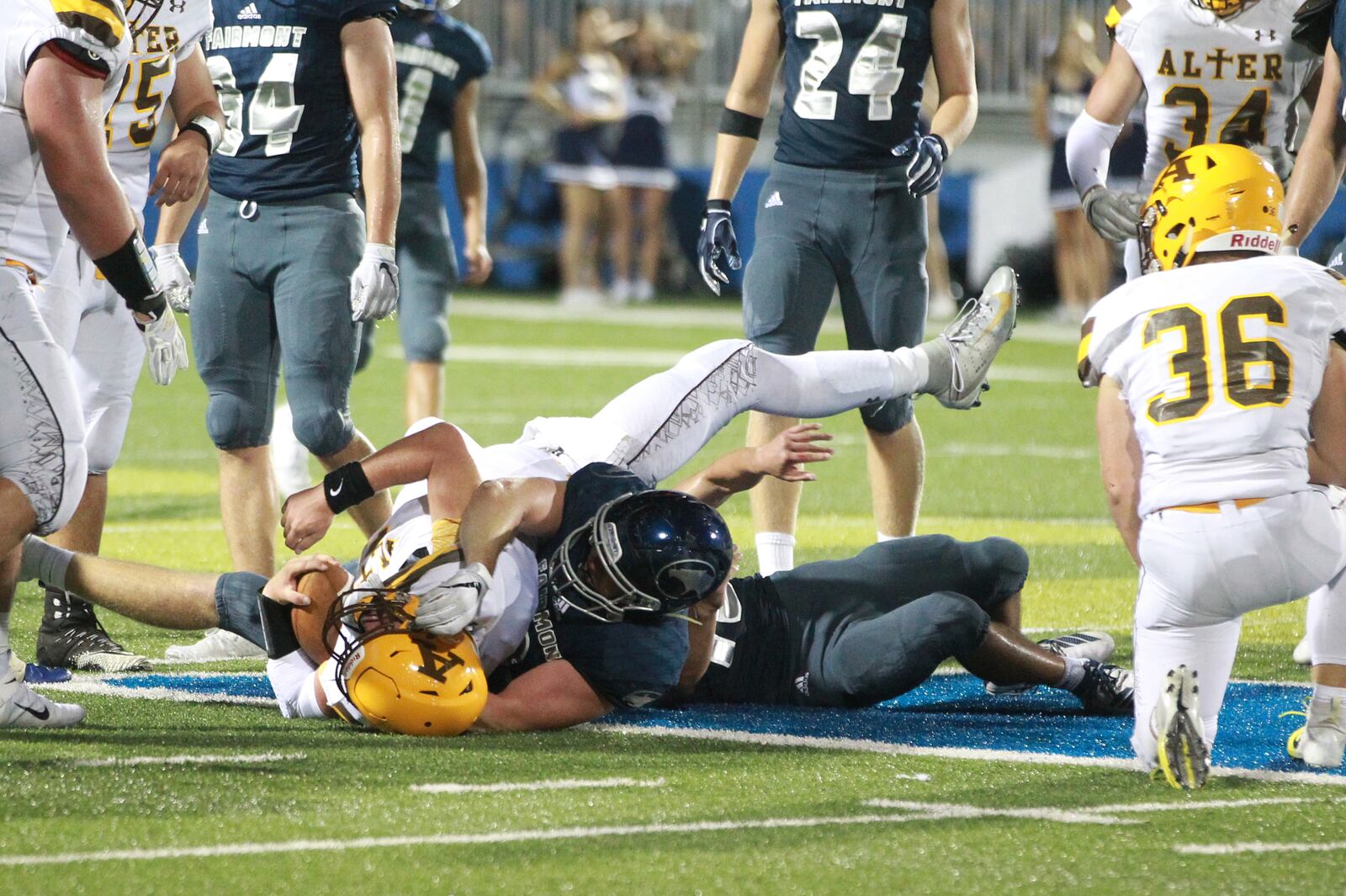 Alter QB Kale Steneman (with ball) is taken down by Garrett Baker of Fairmont. Alter defeated host Fairmont 21-7 in a Week 1 high school football game on Thursday, Aug. 29, 2019. MARC PENDLETON / STAFF