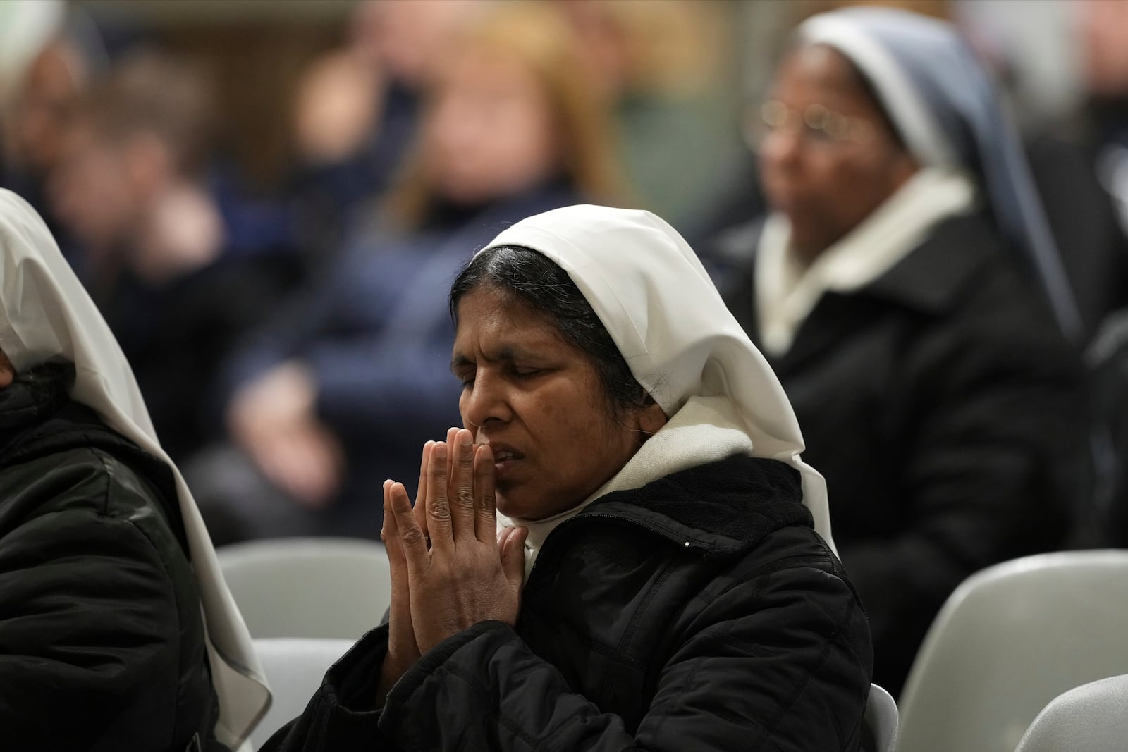 Faithful and nuns gather at St. John Lateran Basilica in Rome Sunday, Feb. 23, 2025, to pray for Pope Francis who was admitted over a week ago at Rome's Agostino Gemelli Polyclinic and is in critical condition. (AP Photo/Alessandra Tarantino)