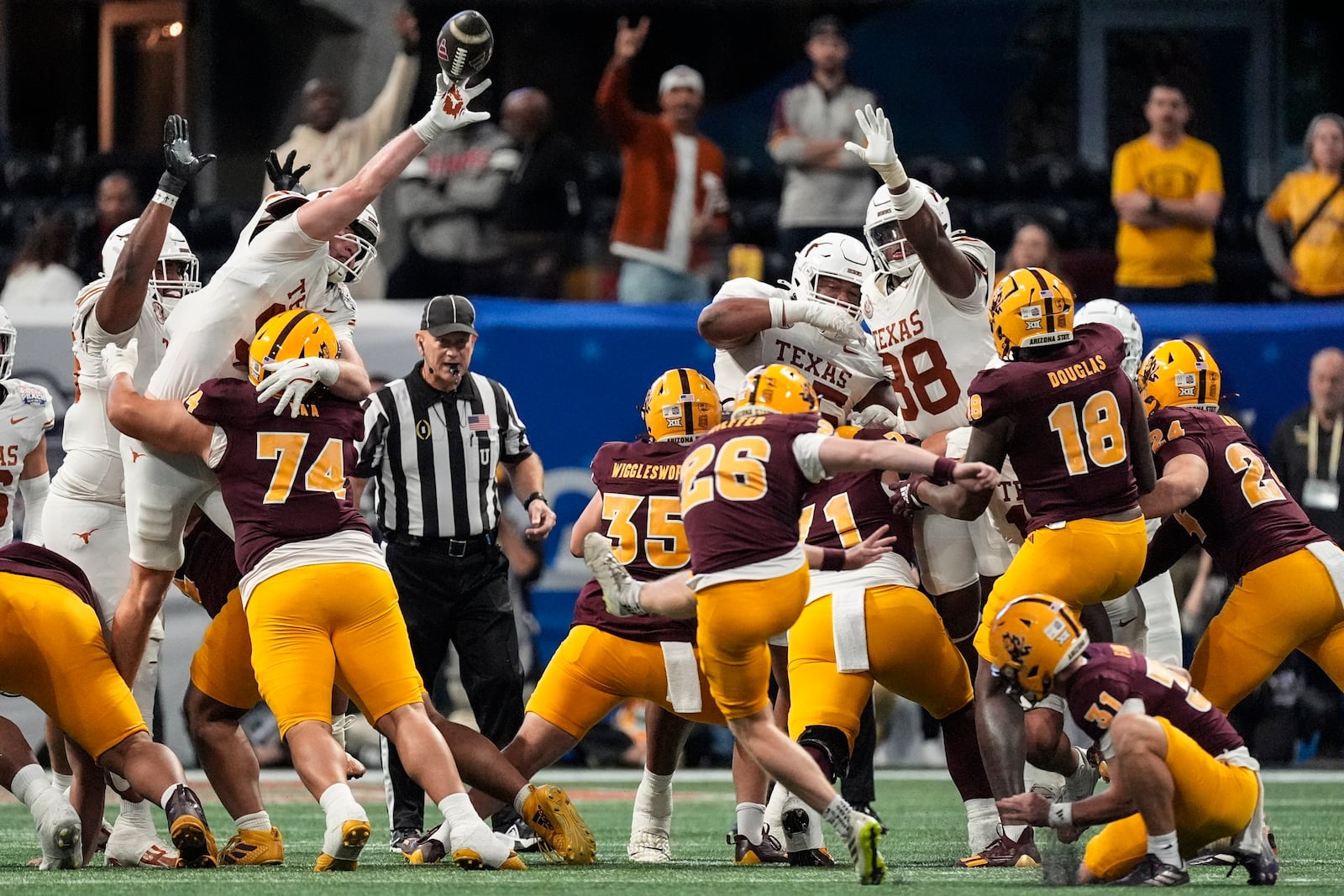 Texas linebacker Ethan Burke (91) blocks a field goal attempt against Arizona State during the first half in the quarterfinals of a College Football Playoff, Wednesday, Jan. 1, 2025, in Atlanta. (AP Photo/John Bazemore)