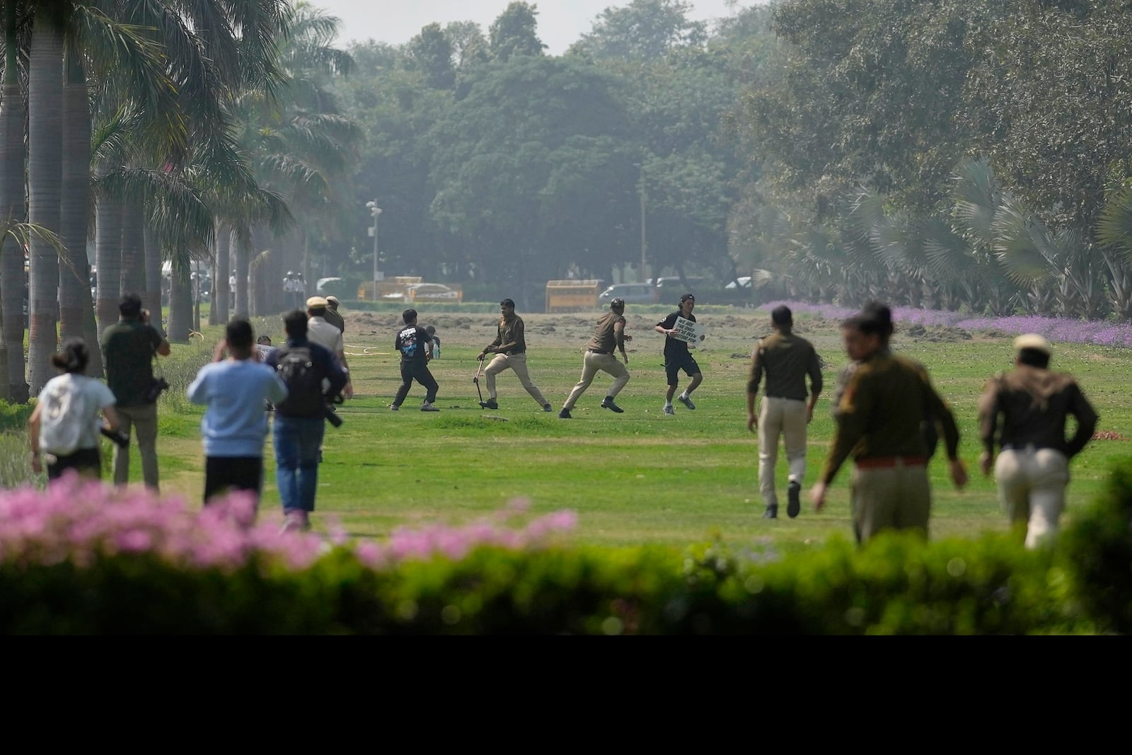 Policemen chase exiled Tibetans during a protest outside the Chinese embassy to mark the 1959 uprising in Tibet against the Chinese rule, in New Delhi, India, Monday, March, 10, 2025. (AP Photo/Manish Swarup)