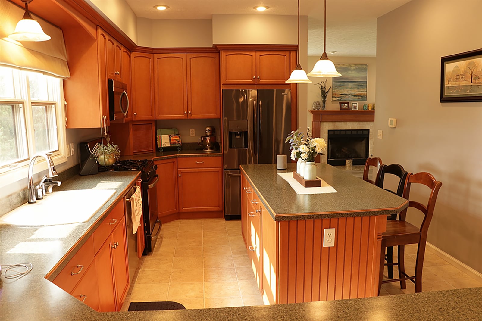 The kitchen island has a foot-bar and seating for up to four as well as additional storage. A peninsula counter divides the kitchen from the breakfast room, which has patio doors that open to a rear balcony deck covered by a pergola. CONTRIBUTED PHOTO BY KATHY TYLER