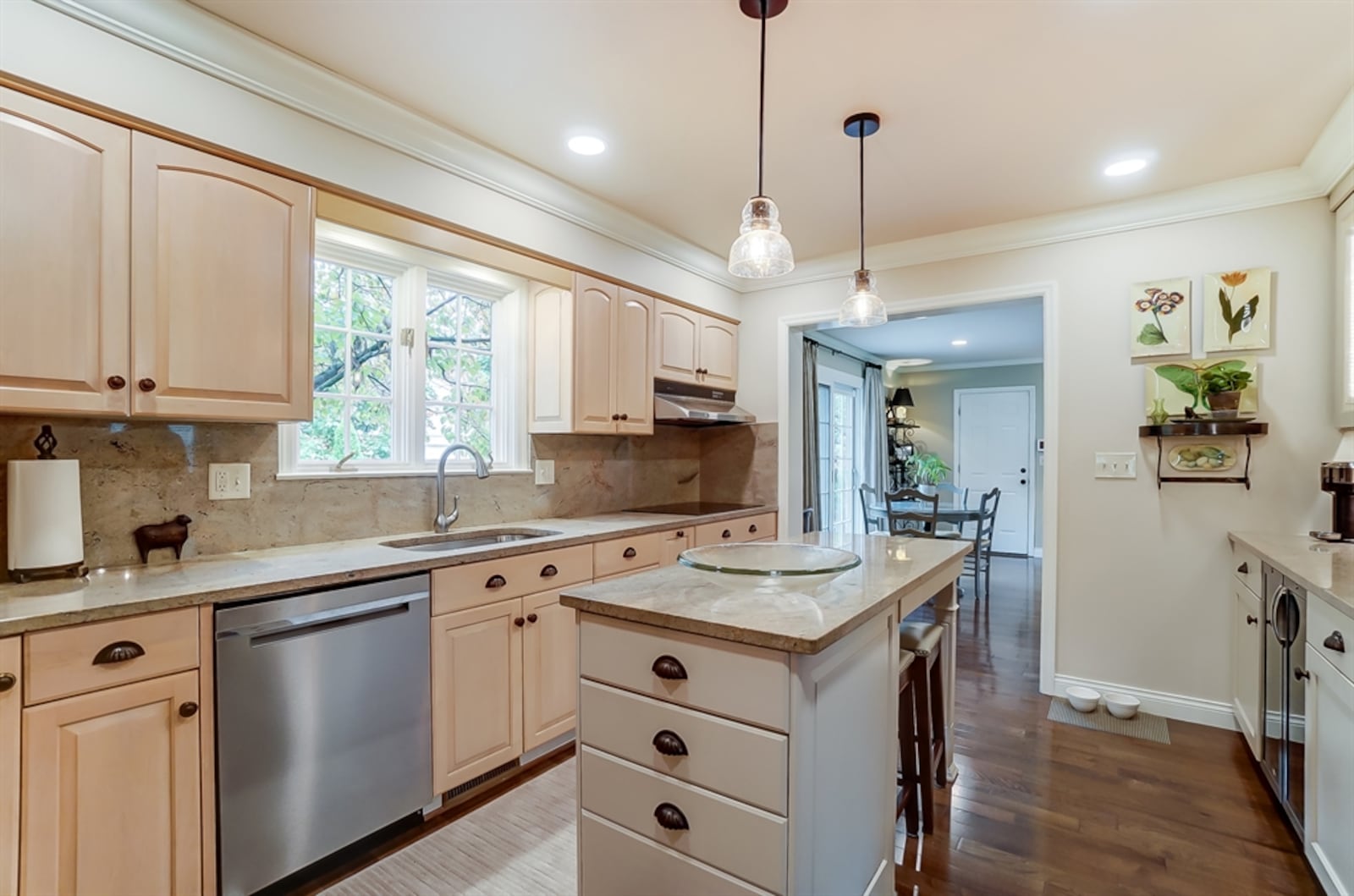 The updated kitchen features double-wall ovens, a buffet bar with bubble-glass cabinet doors and a dual wine and beverage cooler.