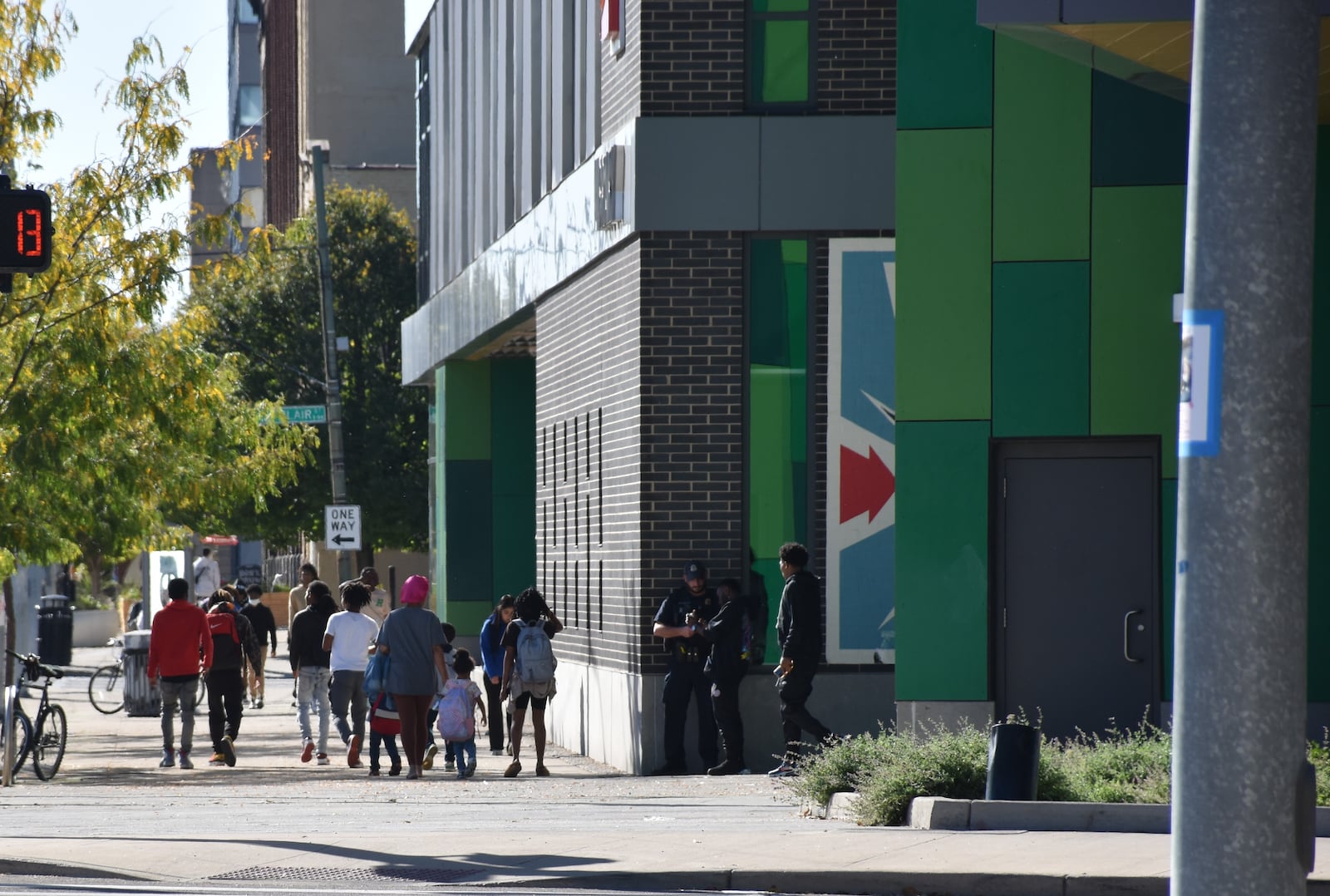 Dayton police officers stand guard outside of the downtown Dayton Metro Library in October 2024. CORNELIUS FROLIK / STAFF