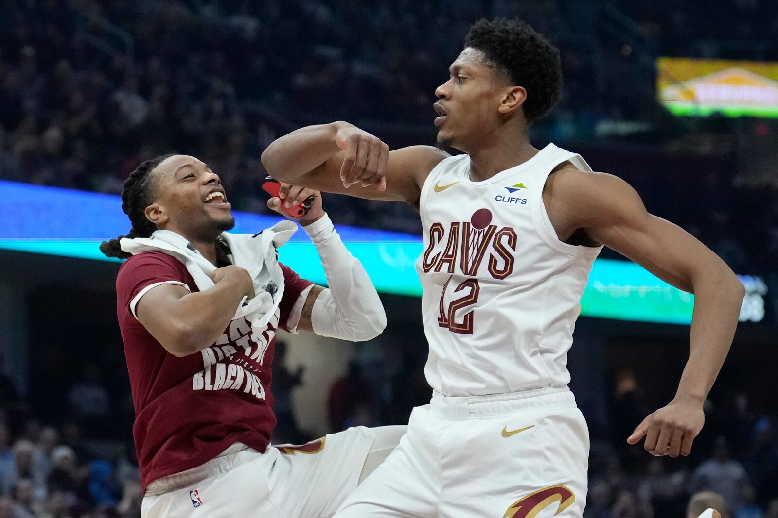 Cleveland Cavaliers forward De'Andre Hunter, right, celebrates with teammate Darius Garland, left, after a basket in the first half of an NBA basketball game against the Minnesota Timberwolves, Monday, Feb. 10, 2025, in Cleveland. (AP Photo/Sue Ogrocki)