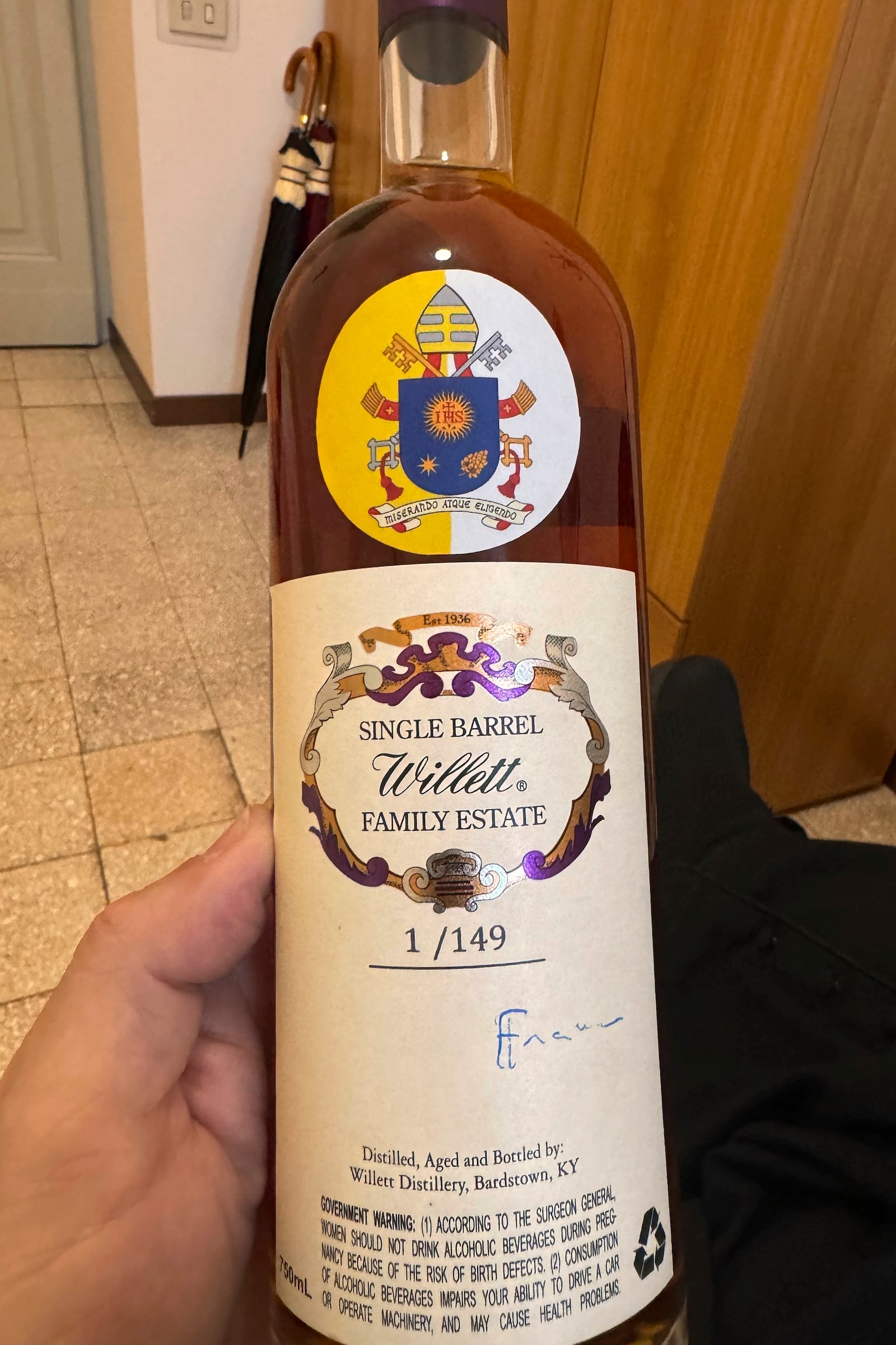 Rev. Jim Sichko holds a bottle of Kentucky bourbon signed by Pope Francis on May 1, 2024. (Jim Sichko via AP)