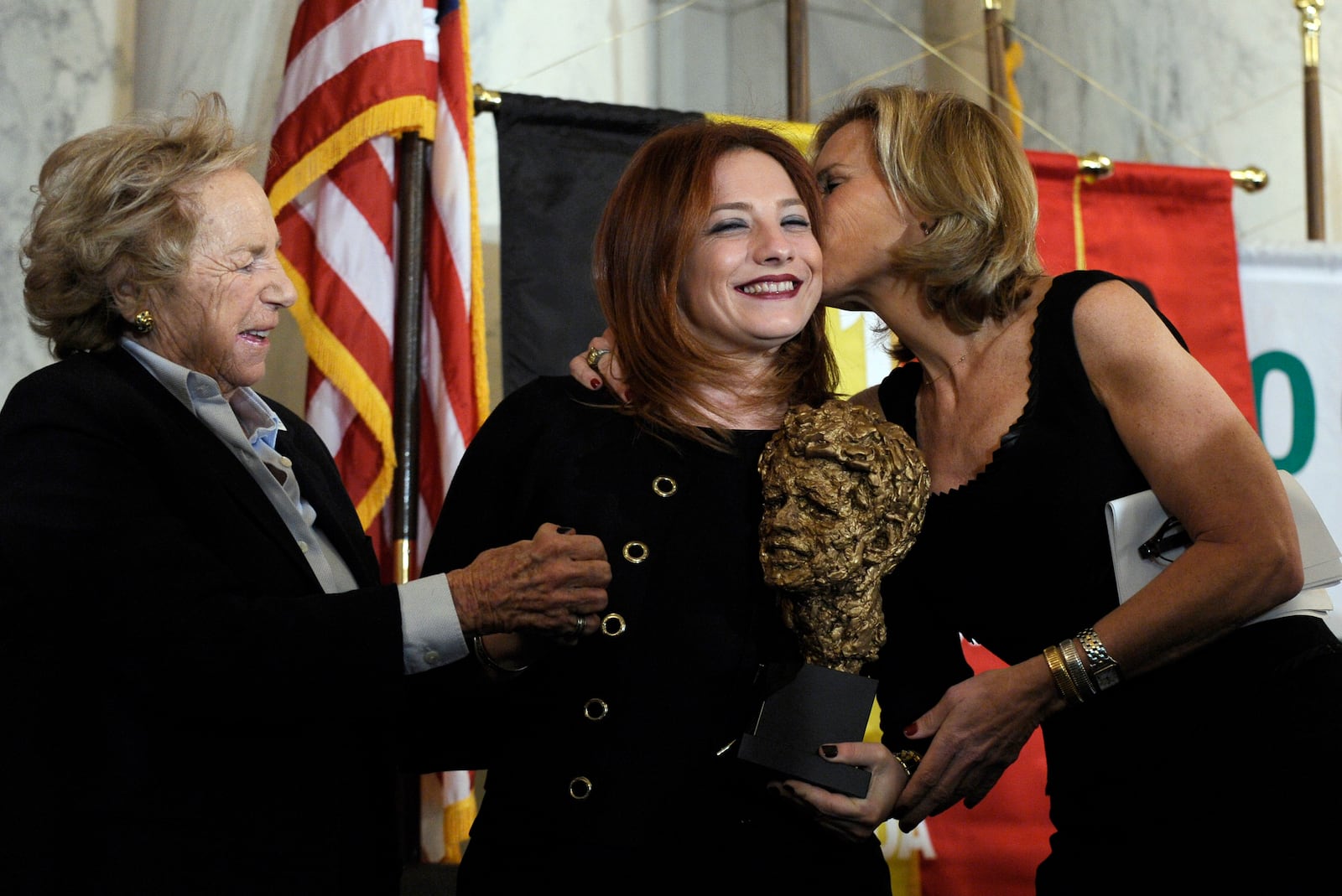 FILE - Egyptian human rights attorney and women's rights activist Ragia Omran, center, gets a kiss on the cheek from Robert F. Kennedy Center President Kerry Kennedy, right, accompanied by Ethel Kennedy, left, during the presentation of the RFK Human Rights Award, Nov. 21, 2013, on Capitol Hill in Washington. (AP Photo/Susan Walsh, File)