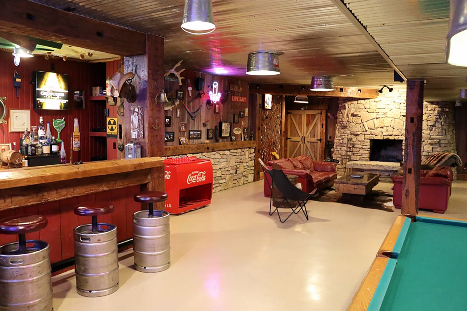 In the lower level, a stack-stone, wood-burning fireplace has a stone-shelf hearth, and light fixtures are made from metal wash tubs and water troughs. CONTRIBUTED PHOTO BY KATHY TYLER