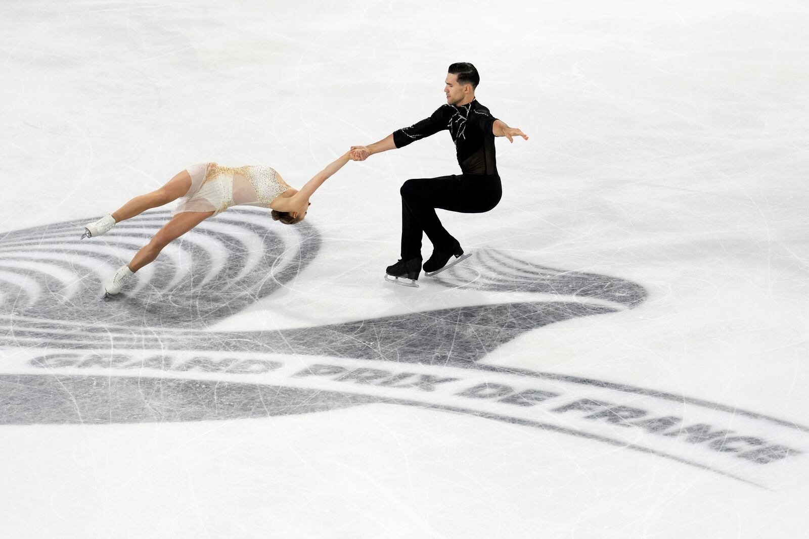 Minerva Fabienne Hase and Nikita Volodin, of Germany, compete in the pairs' free skating segment at the ISU Grand Prix of Figure Skating, Saturday, Nov. 2, 2024, in Angers, France. (AP Photo/Aurelien Morissard)