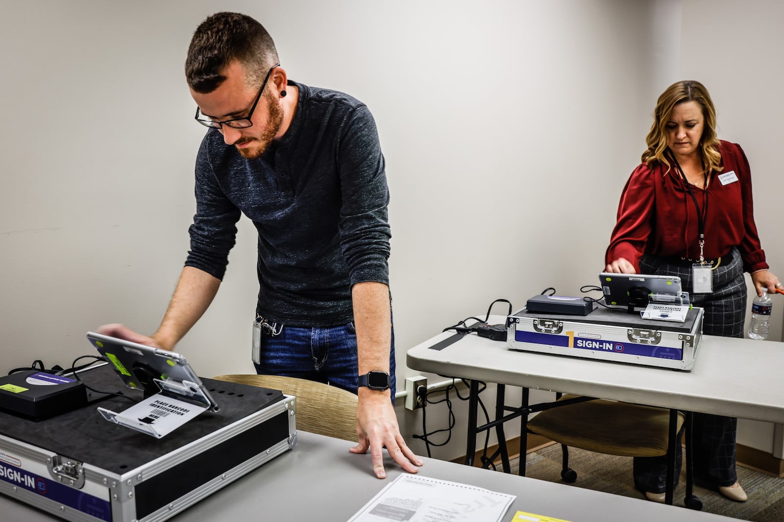 Montgomery County Voter Service Worker, Connor Morrow, left and Deputy Director of the Montgomery County Board of Elections, Sarah W. Greathouse resets training equipment at the board of elections Tuesday October 4, 2022. 
Montgomery County Board of Elections is training 800 poll workers for for the Nov. 8 election. JIM NOELKER/STAFF