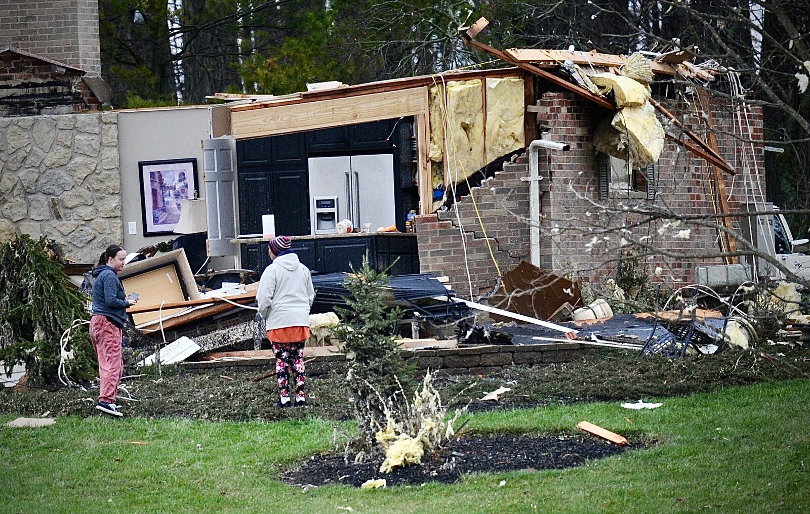 Homeowners survey the damage to their home in the area of Klinger and Rangeline roads in Miami County after strong winds destroyed it Thursday evening, March 14, 2024. MARSHALL GORBY \STAFF