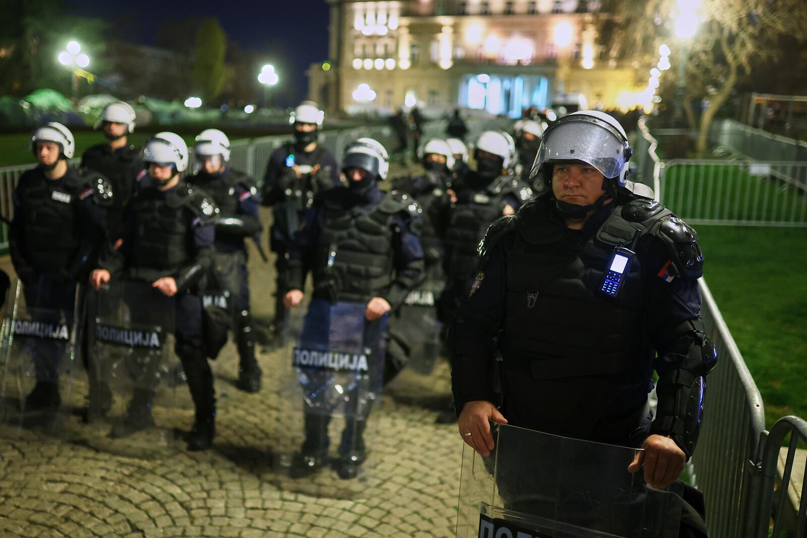 Serbian anti-riot police stand near the Parliament building ahead of a major rally this weekend in downtown Belgrade, Serbia, Friday, March 14, 2025. (AP Photo/Armin Durgut)