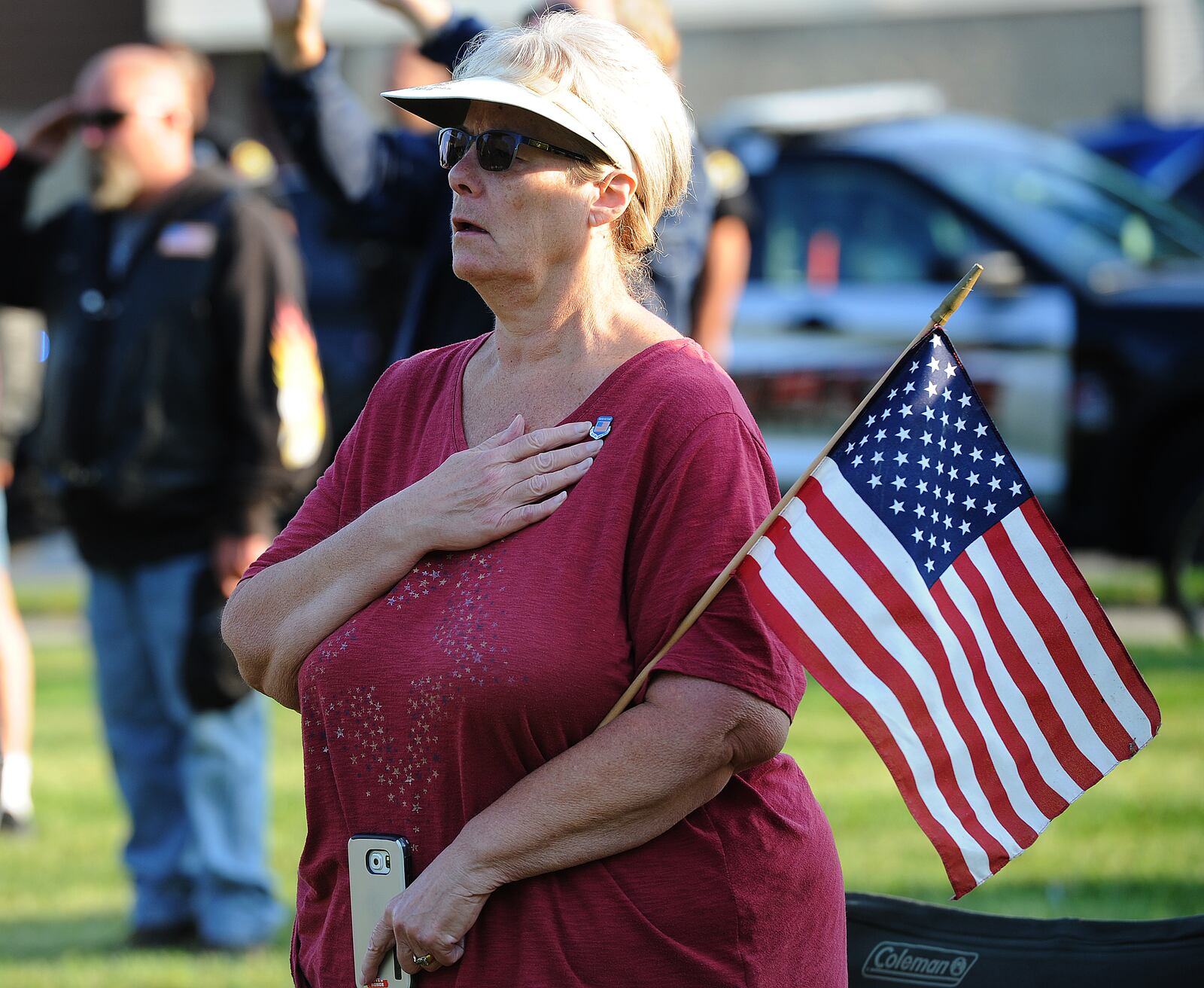 Kim Duncan places her hand over her heart during the 20th annual 9/11 Memorial Ceremony in Fairborn Saturday, Sept. 11, 2021 on the front lawn of Calamityville, the National Center for Medical Readiness. MARSHALL GORBY/STAFF

