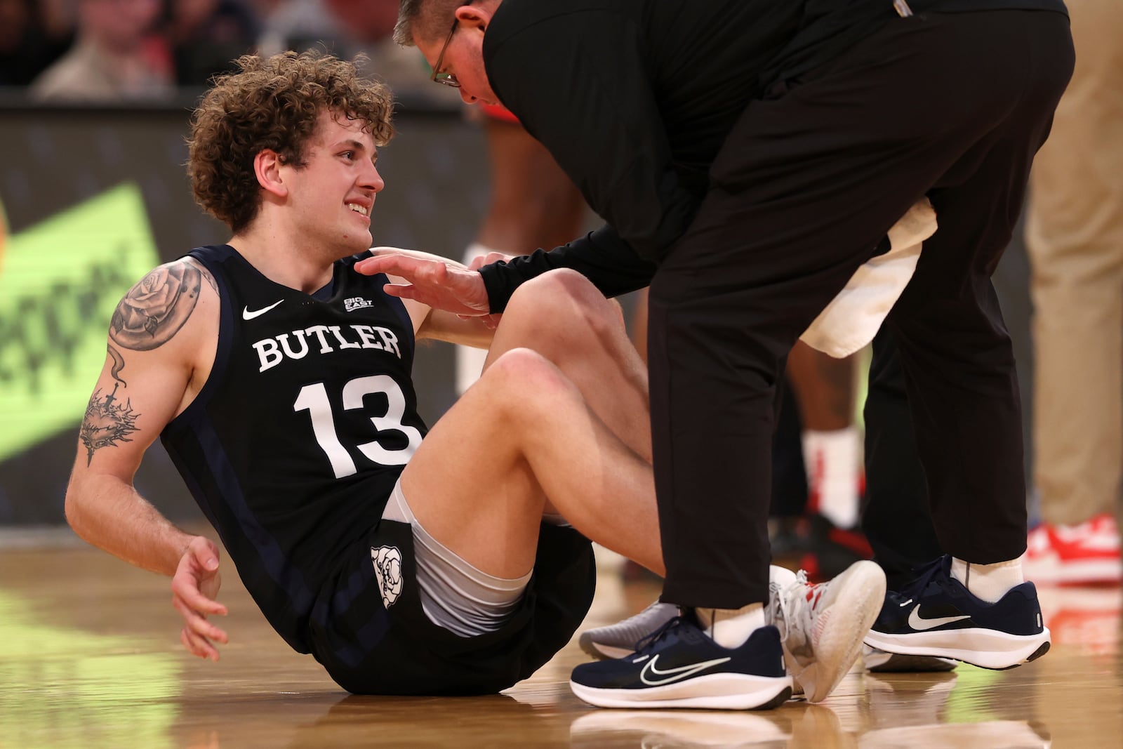 Butler guard Finley Bizjack (13) reacts to an apparent injury during the second half of an NCAA college basketball game against St. John's in the quarterfinals of the Big East Conference tournament, Thursday, March 13, 2025, in New York. (AP Photo/Pamela Smith)