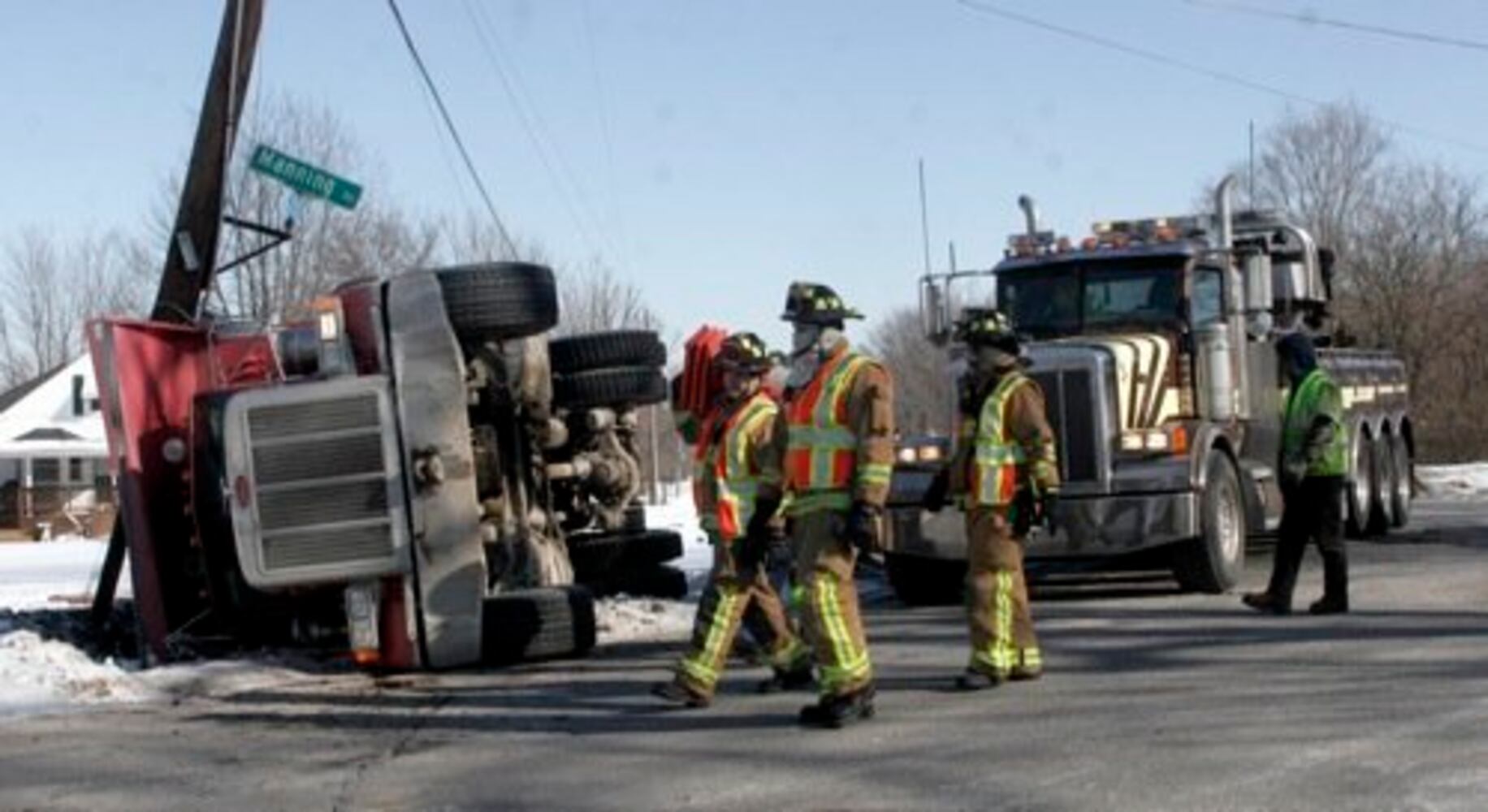 Dump truck flips onto its side