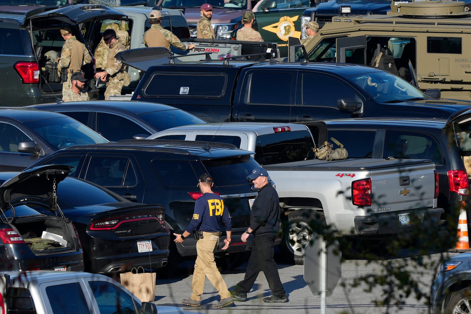 FILE - Law enforcement personnel are staged in a school parking lot during a manhunt for Robert Card in the aftermath of a mass shooting in Lewiston, Maine, Oct. 27, 2023. (AP Photo/Matt Rourke, File)