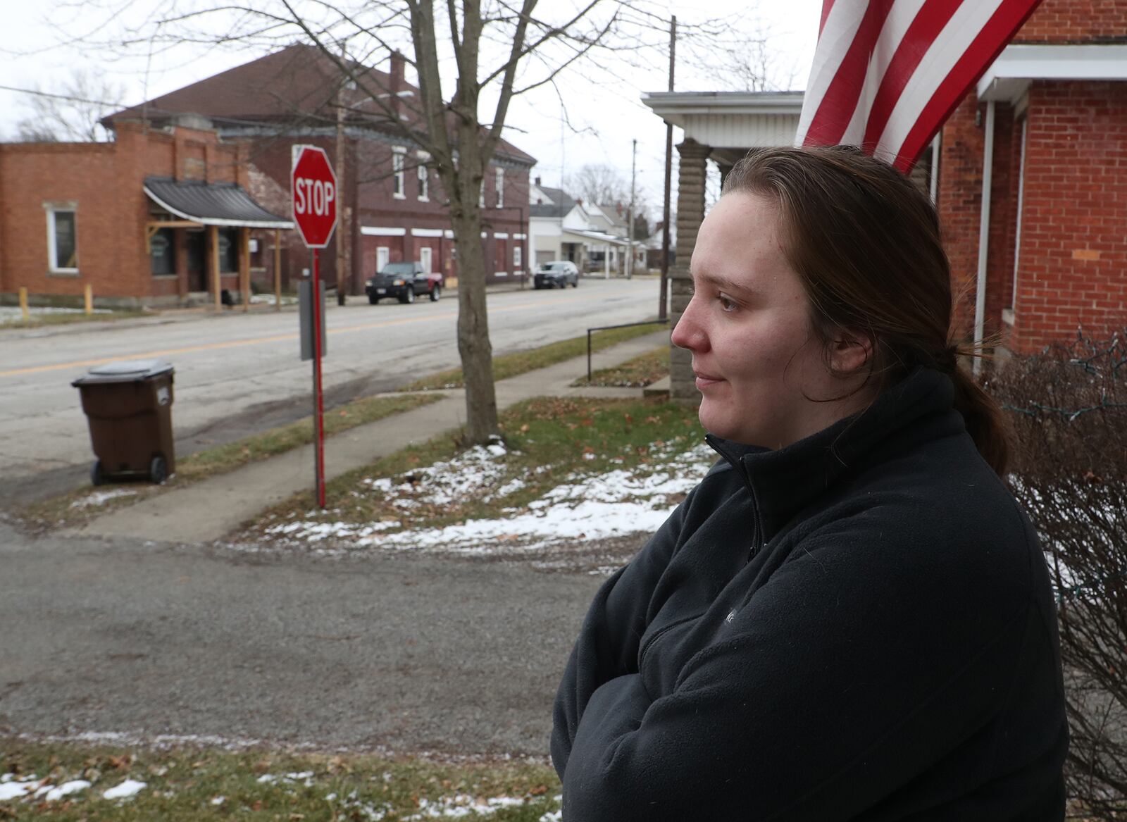 Victoria Loy talks about the night she was awakened by federal agents raiding the Jolly Roger Bar & Grill in Woodstock looking for Jessica Watkins in connection with the storming of the Capital Building in Washington. The Jolly Roger is the brown building in the background. BILL LACKEY/STAFF