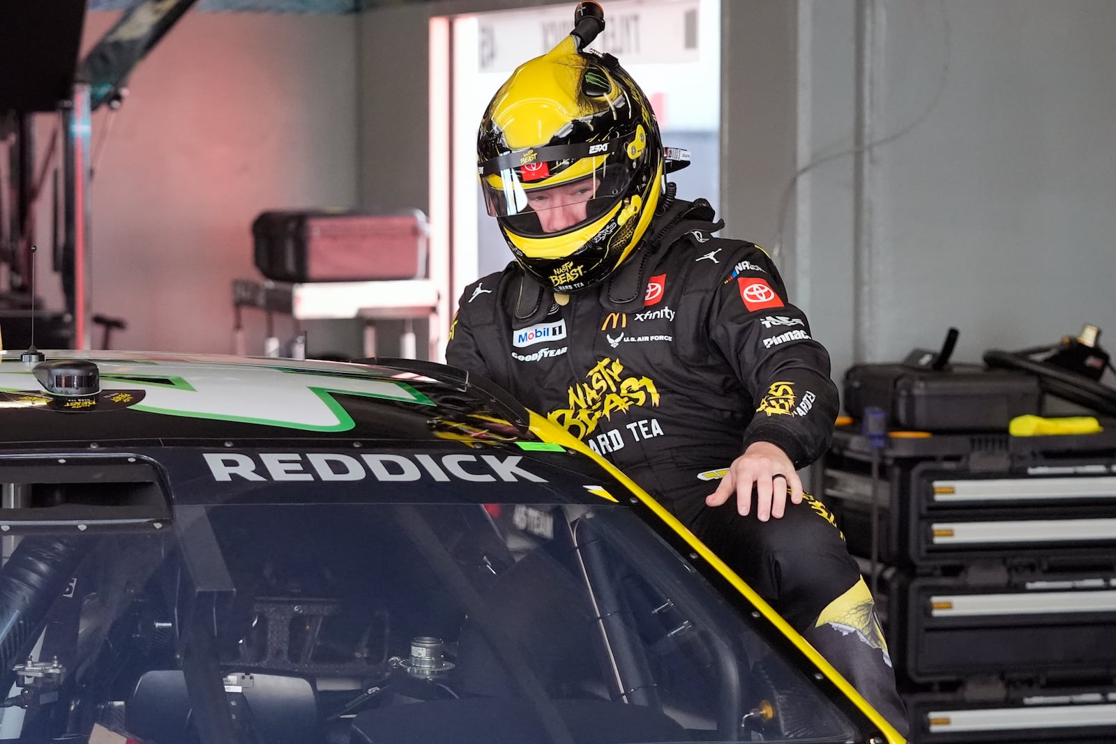 Tyler Reddick climbs into his car during a practice session for the NASCAR Daytona 500 auto race at Daytona International Speedway, Wednesday, Feb. 12, 2025, in Daytona Beach, Fla. (AP Photo/John Raoux)