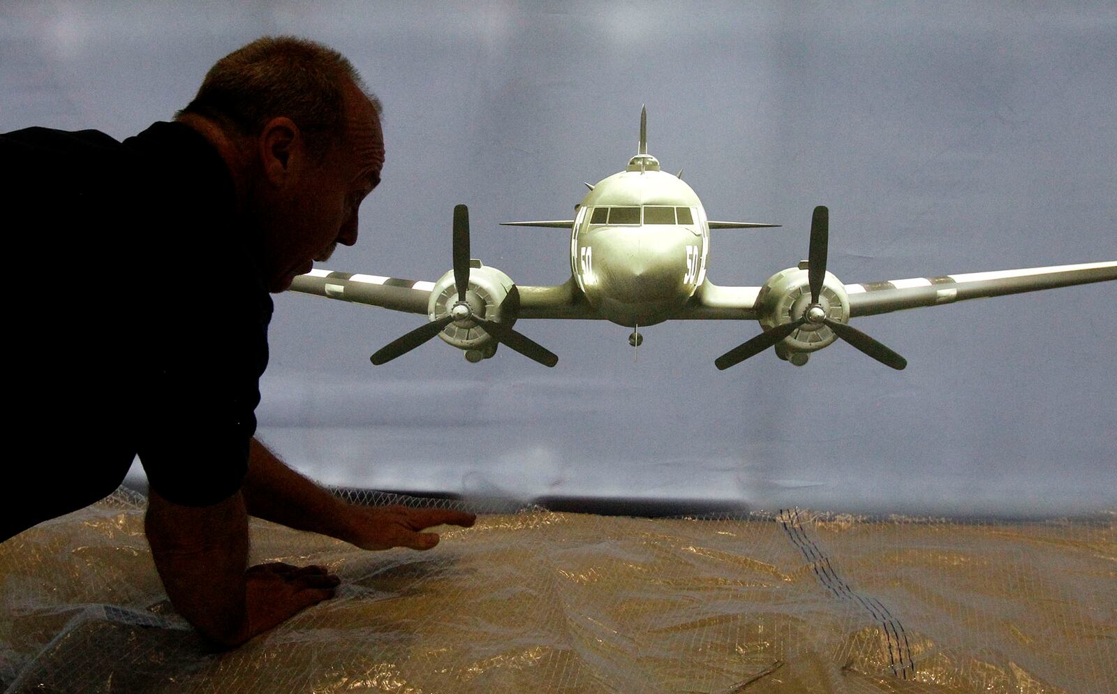 Tim Kelly completes the new DDAY75 exhibit at the National Museum of the U. S. Air Force last Friday.  The new D-Day Freedom From Above exhibit opened on Monday.  Visitors can rent tablet computers for $5 for the immersive experience of D-Day paratoopers in the display.  The tablets run the innovative technology HistoPad, designed by the French company Histovery.   TY GREENLEES / STAFF