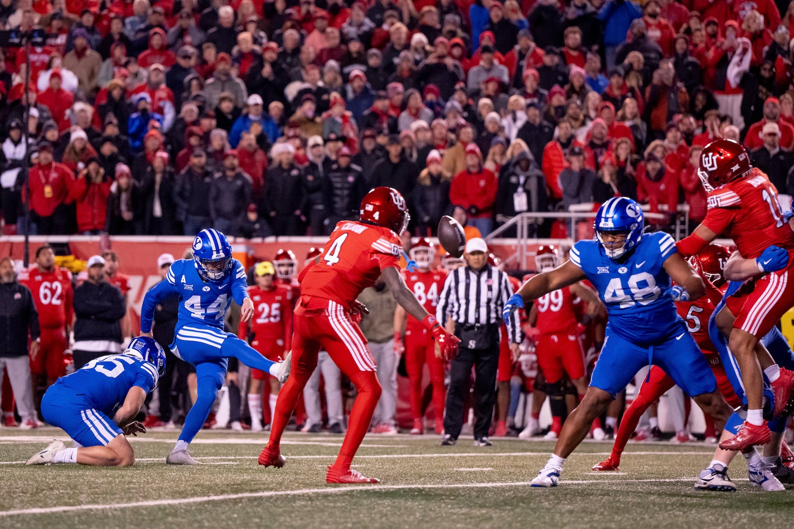 BYU place kicker Will Ferrin (44) kicks a game-winning field goal in the second half of an NCAA college football game against Utah, just after midnight on Sunday, Nov. 10, 2024, in Salt Lake City. (AP Photo/Spenser Heaps)