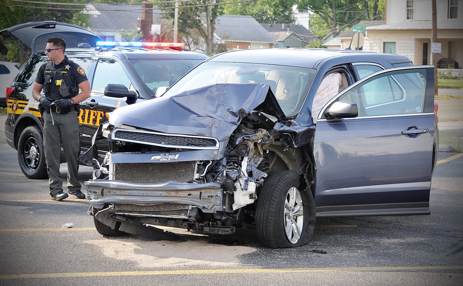 A hit-and-run driver who crashed into two vehicles was pinned by two cruisers following a slow-speed pursuit in New Carlisle. MARSHALL GORBY/STAFF