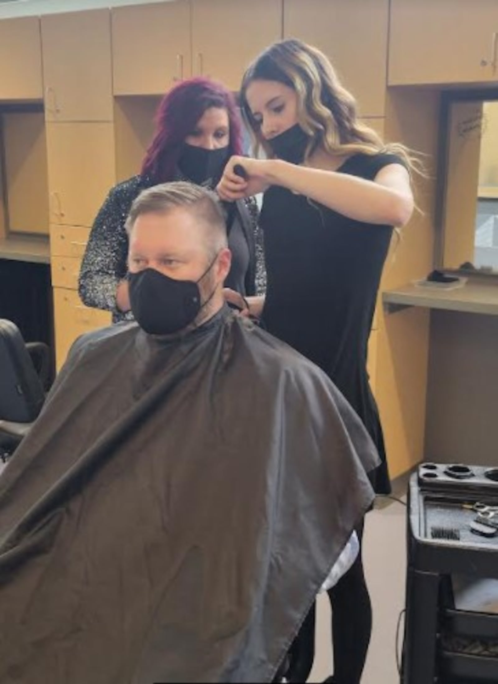 A ribbon-cutting ceremony was held in 2021 for The Salon@Fairmont, a part of the Cosmetology program in the Fairmont Career Tech Center. Fairmont principal Tyler Alexander (pictured) and Superintendent Scott Inskeep were the first two clients to get haircuts from senior Cosmetology students Haylie Roark and Faith Bennett, respectively.